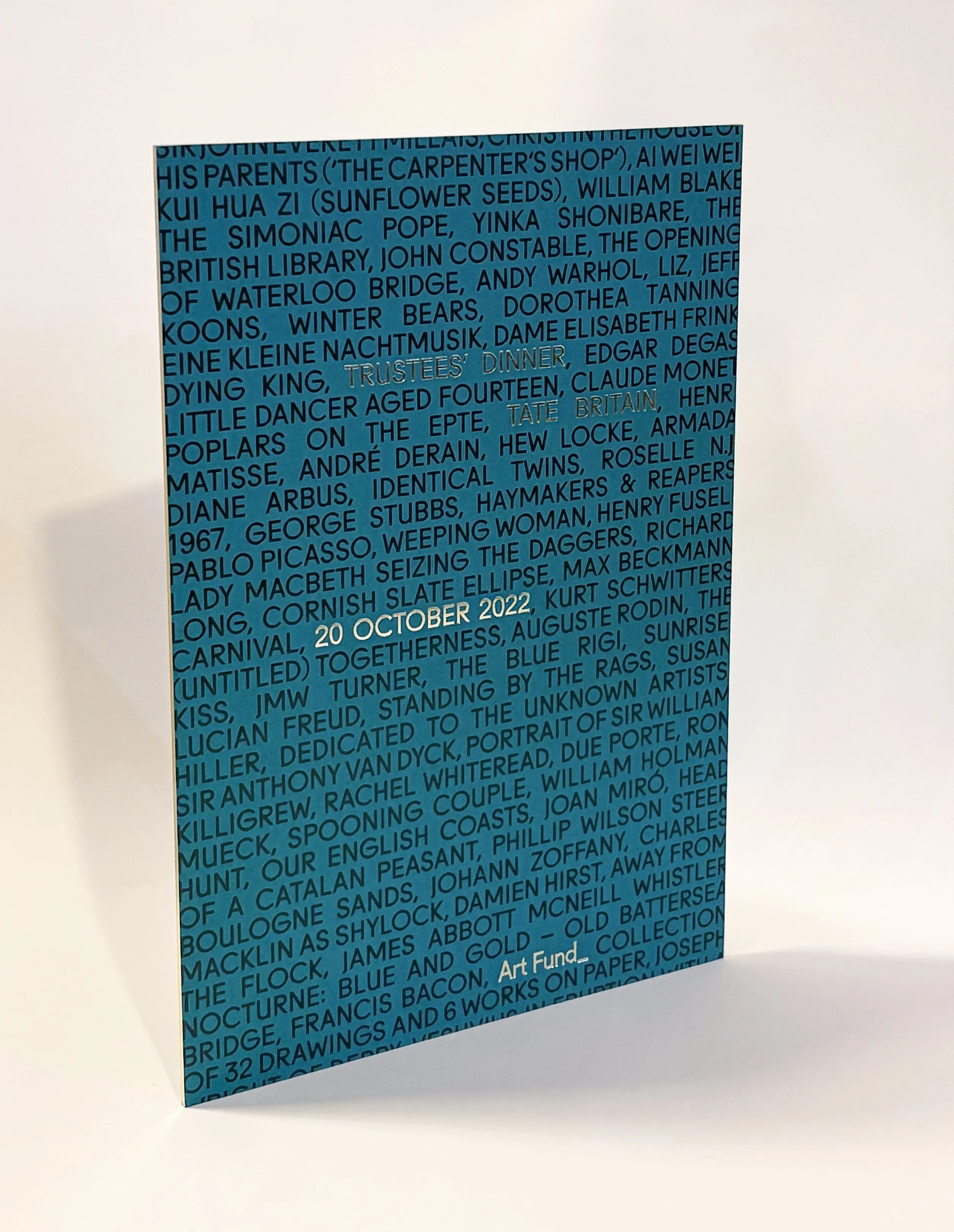 A rectangular artwork with blue background and black text, featuring names of artists, writers, and historical figures, with some sections in silver and gold, titled 'Trustees' Dinner' and dated '20 October 2022'.