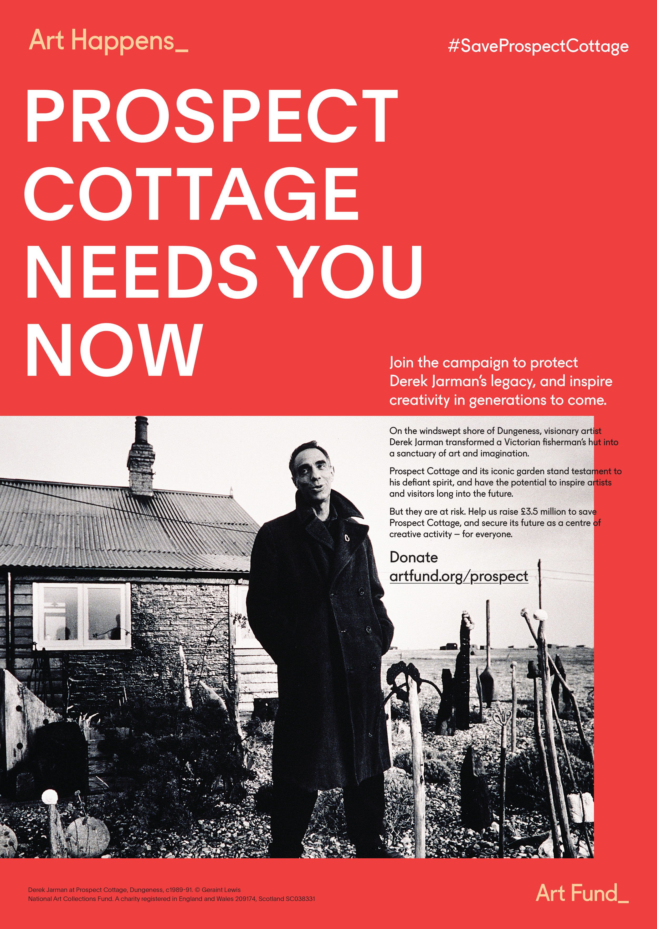 A black and white photograph of Derek Jarman standing outdoors in front of a small cottage. He is wearing a long coat and looking toward the camera. The background shows a garden with stones and wooden structures, a house with a chimney, and a cloudy