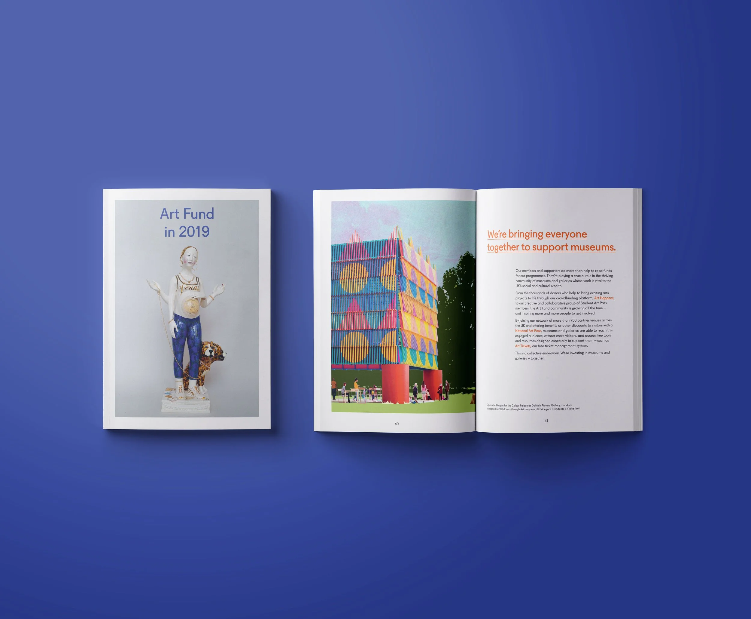 Open magazine with colorful art image and text on a blue background.