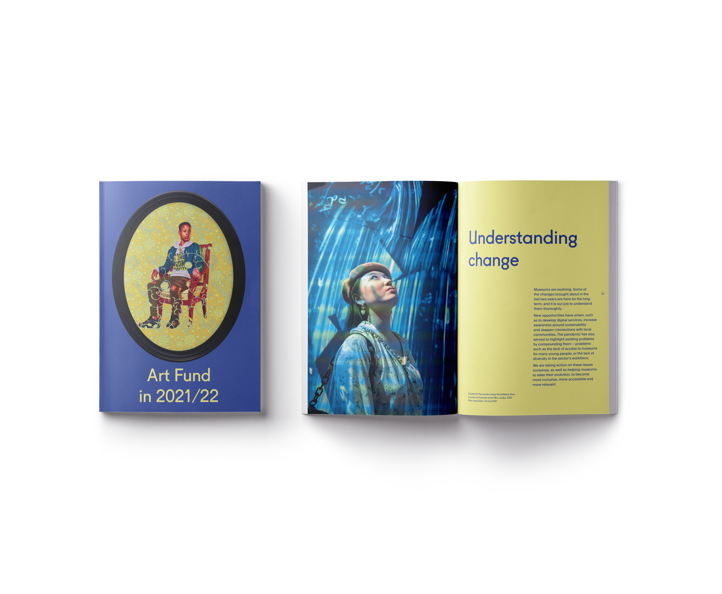 An open magazine with articles and images related to art and technology, including a woman in a digital environment, and a section titled 'Art Fund 2021/22'