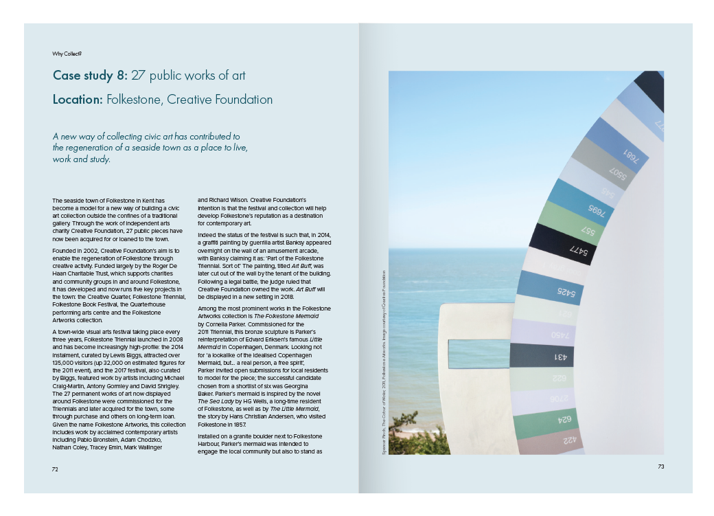 Photograph of a color palette or color swatch fan deck with various shades and color codes, set outdoors with blue sky and greenery in the background.