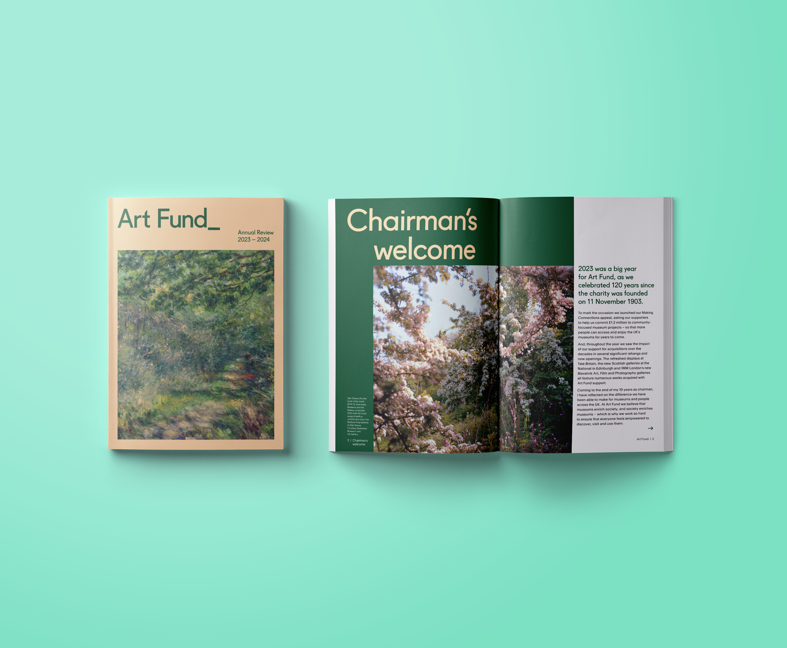 Open magazine with articles about art, featuring images of trees and blossoms, on a light mint green background.