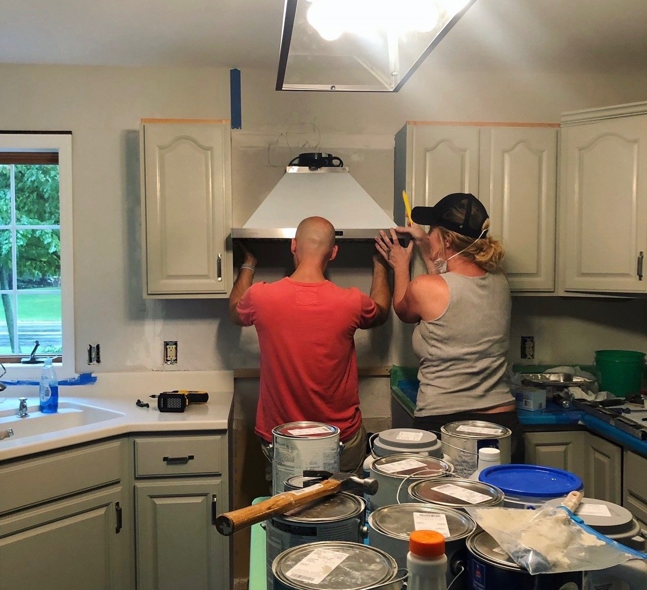 Adam and Stacy renovating a kitchen.
