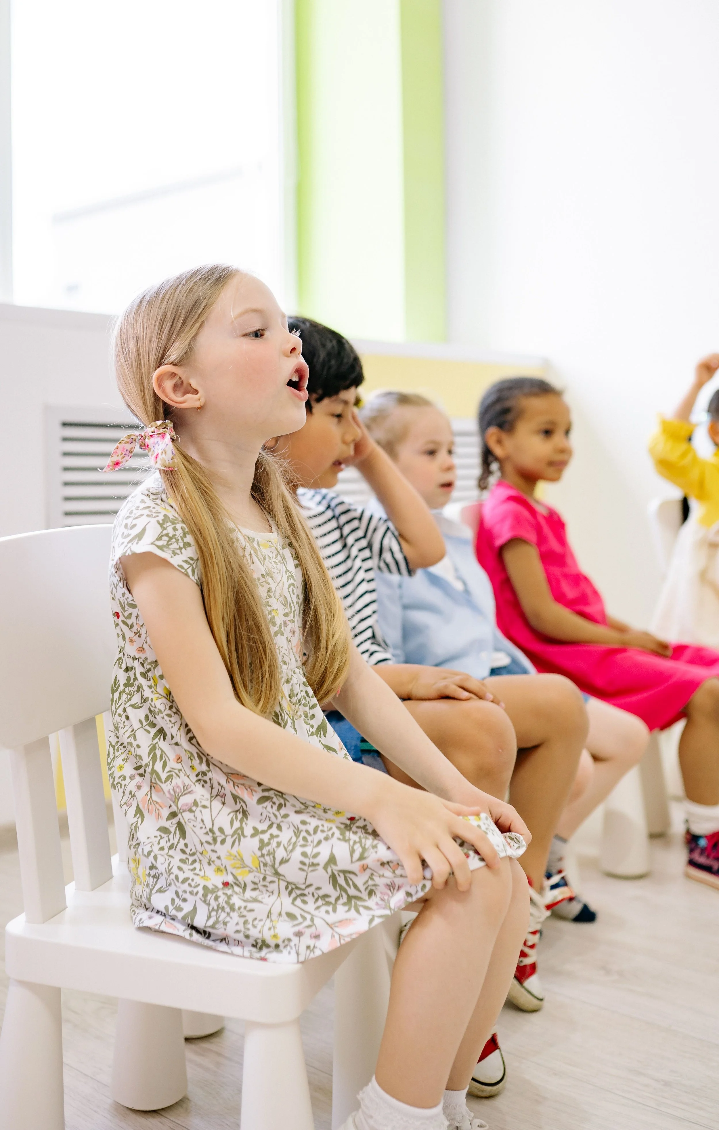 Young children participating in an interactive English language learning session.