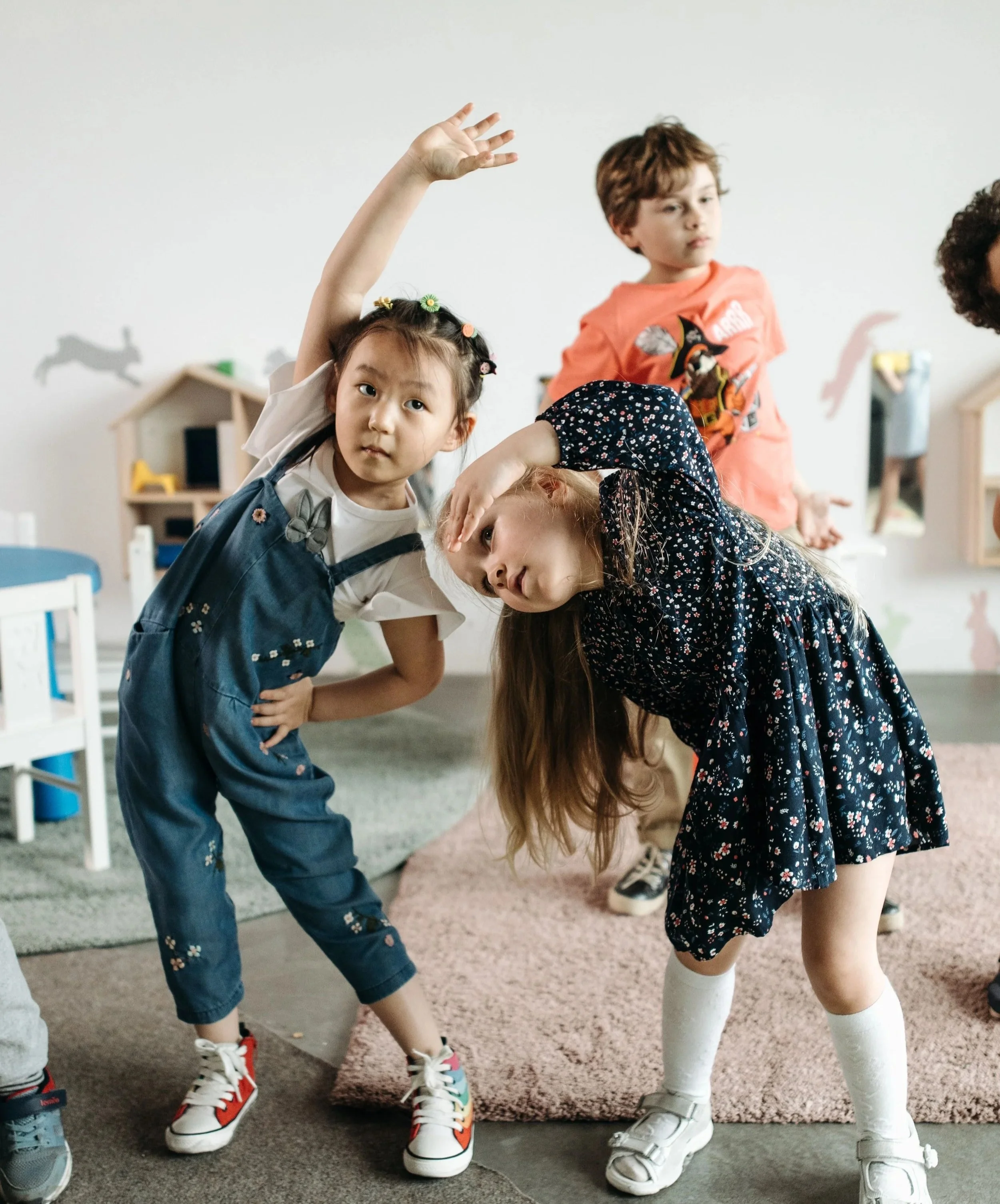 Young children engaged in a fun, immersive English class focused on language acquisition.