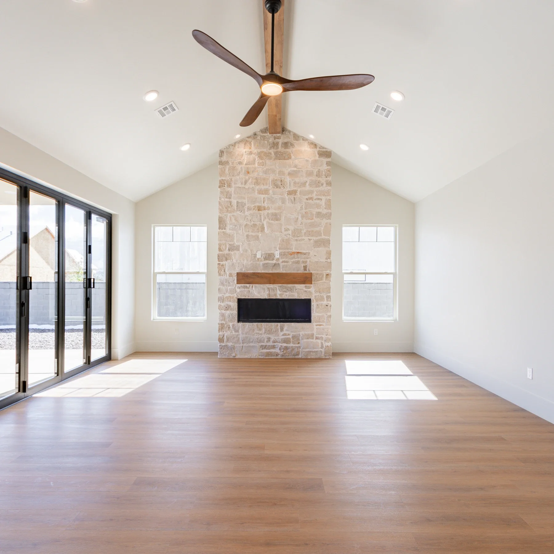 Light, airy modern living room with lofted ceiling and stone accents in Southern Utah home