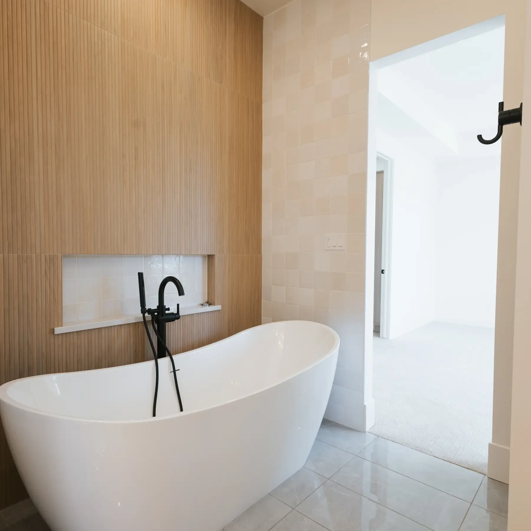 Modern bathroom, with wooden accent wall, and standalone tub