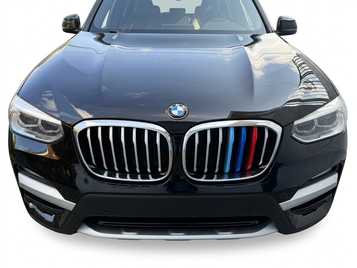 Front view of a black BMW car with a BMW logo on the hood and a kidney grille with blue and red accents on the grille.