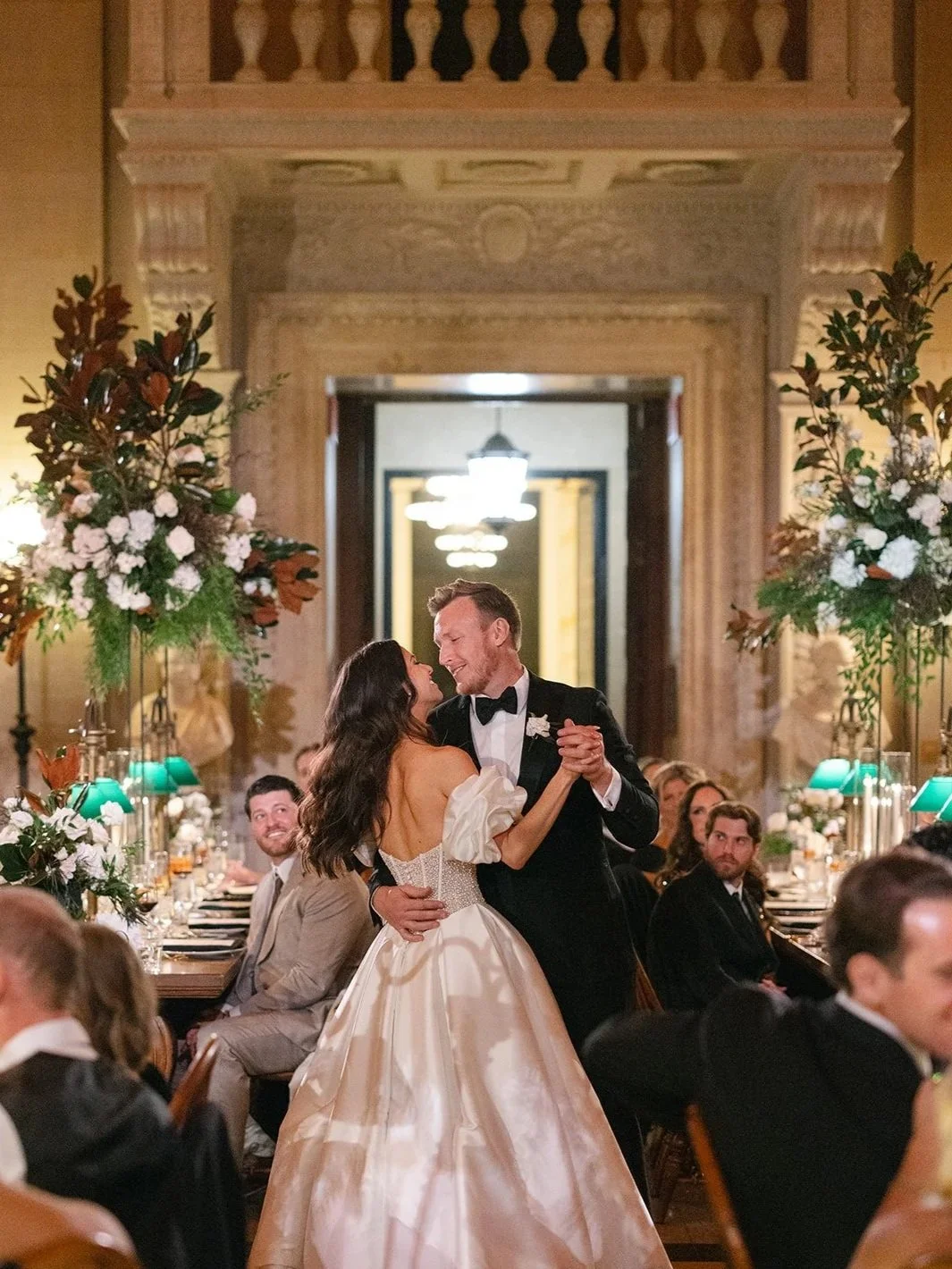 A bride and groom dancing during their wedding at the Boston Public Library.
