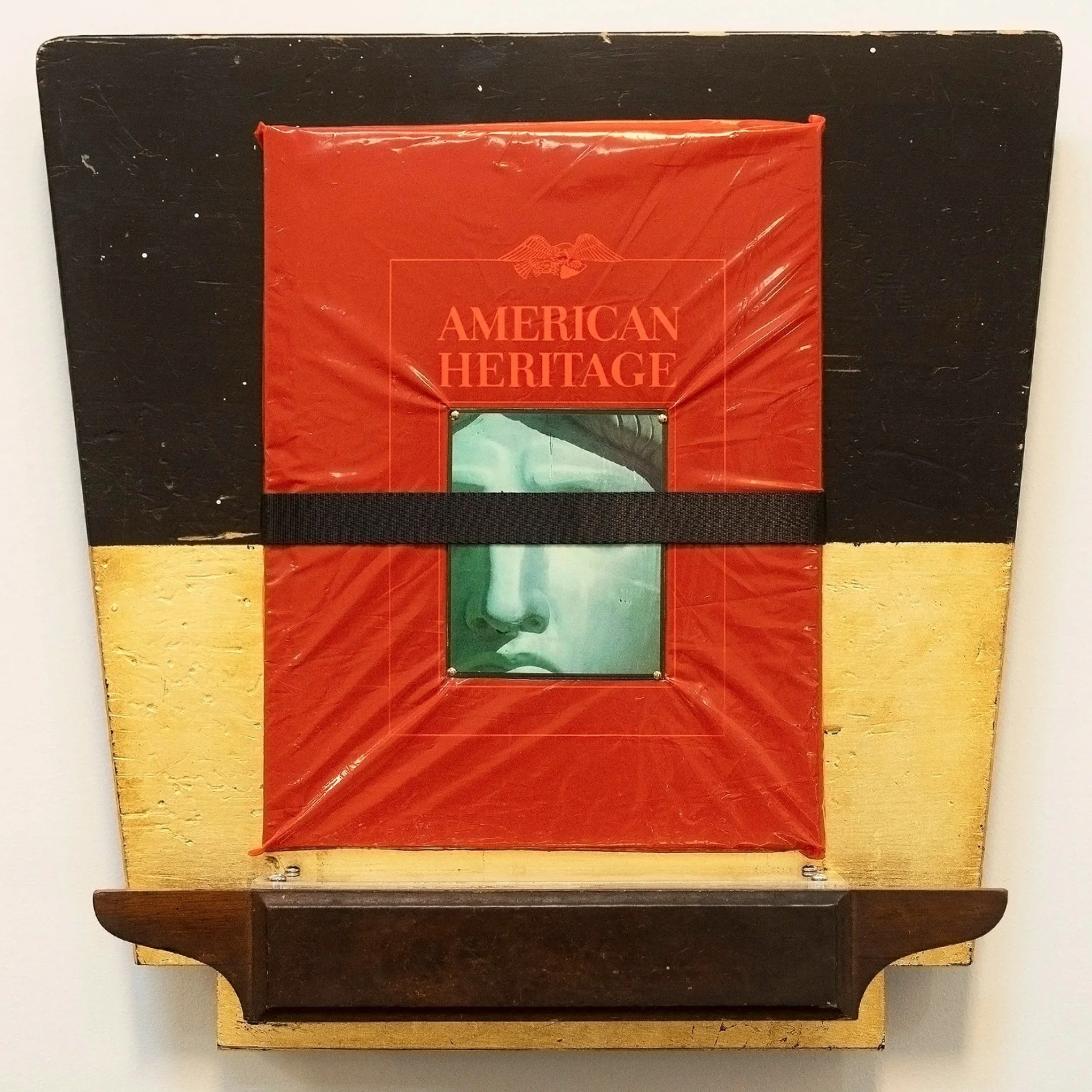 A wooden chessboard with a red box labeled "American Heritage" placed on top of it.