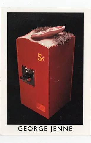 A vintage red cigarette vending machine shaped like a pack of cigarettes with an opening for dispensing and a 5-cent price label, credited to George Jenne.