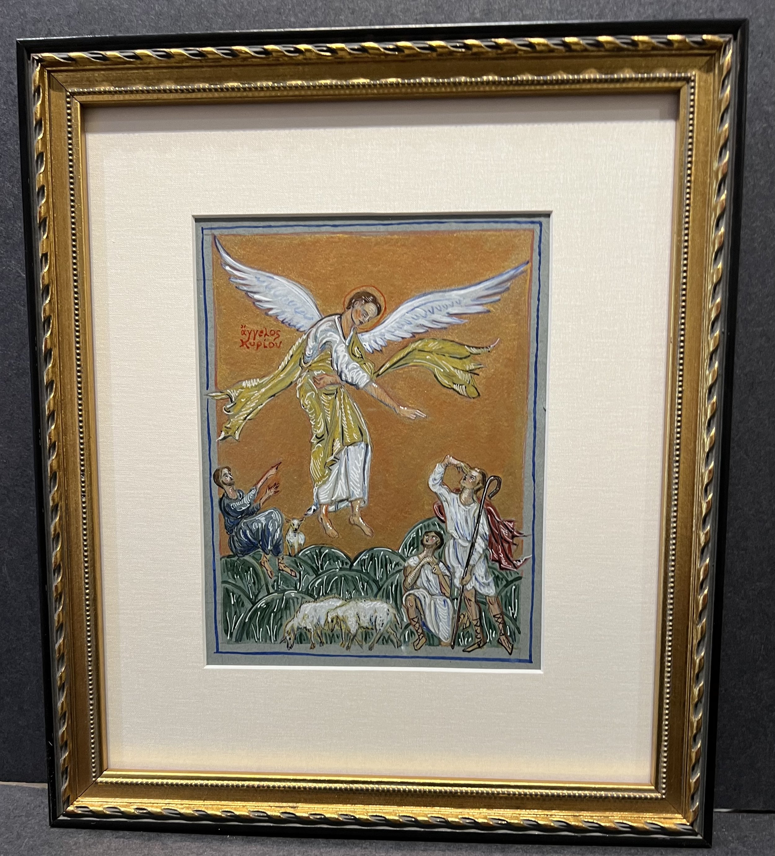 Framed religious painting depicting an angel with large white wings, standing on a cloud with a staff, surrounded by small children and a partially visible figure. The background is gold and the frame is ornate with gold and black accents.