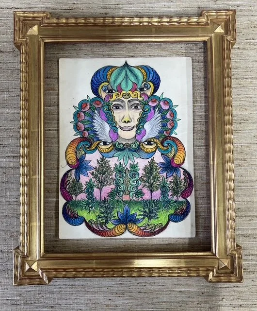 Colorful fantasy illustration of a woman's face with elaborate headdress, surrounded by intricate floral and fantasy elements, enclosed in a gold decorative frame.
