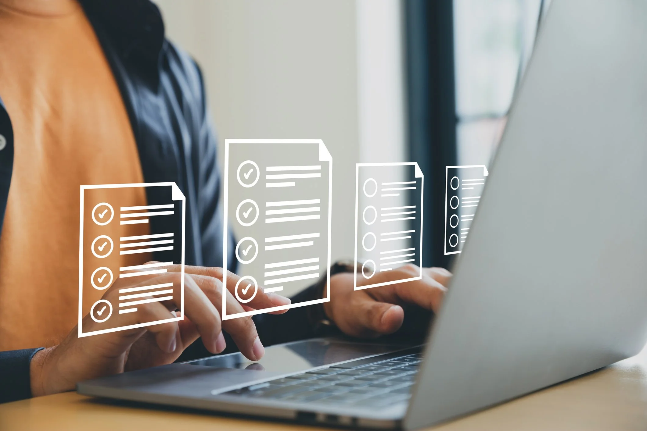Person typing on a laptop with digital overlay of checklists or forms.