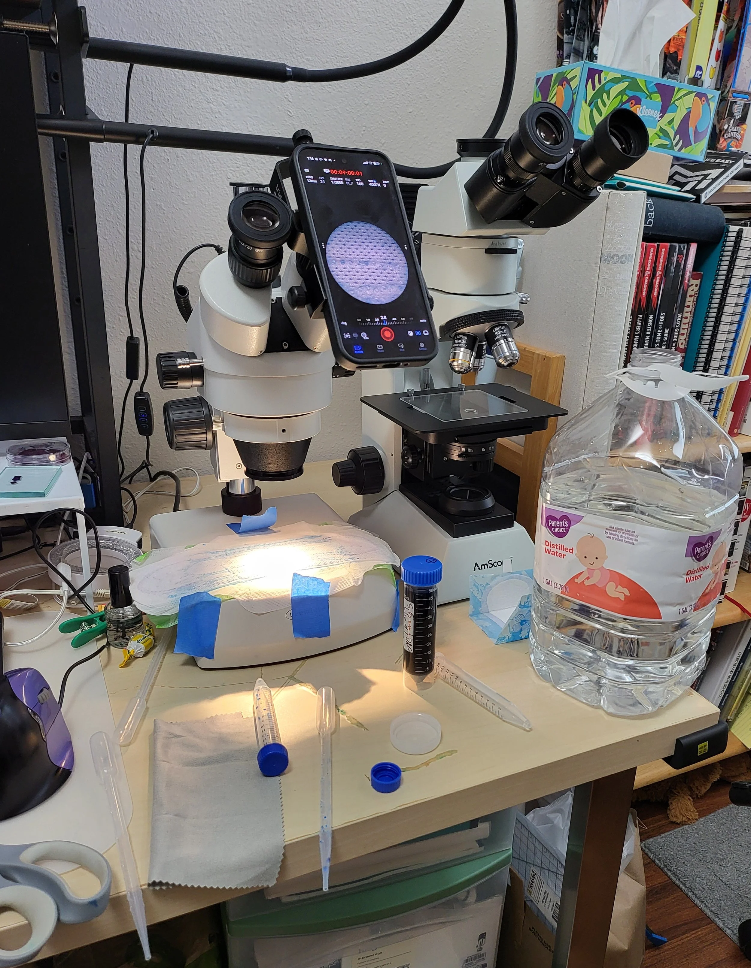 Image of my desk, with a pad painter's taped to a stereo microscope stage