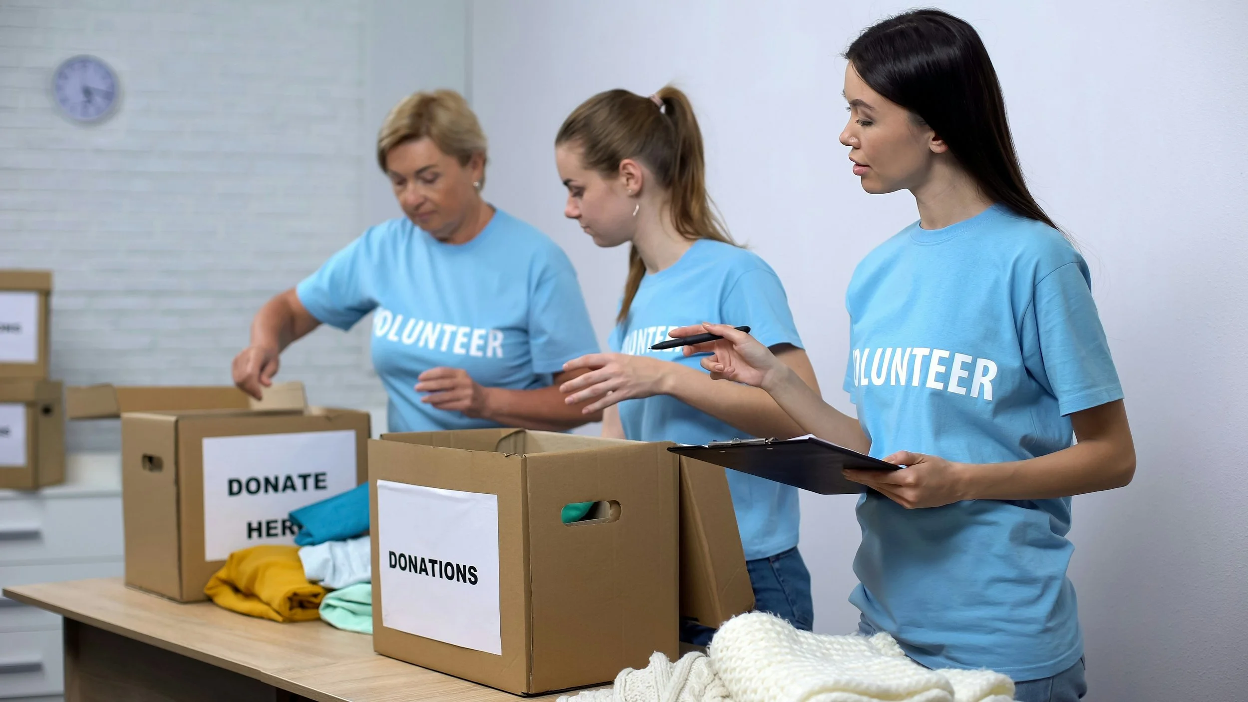 Volunteers sorting donation boxes, reflecting a non-profit's mission in action
