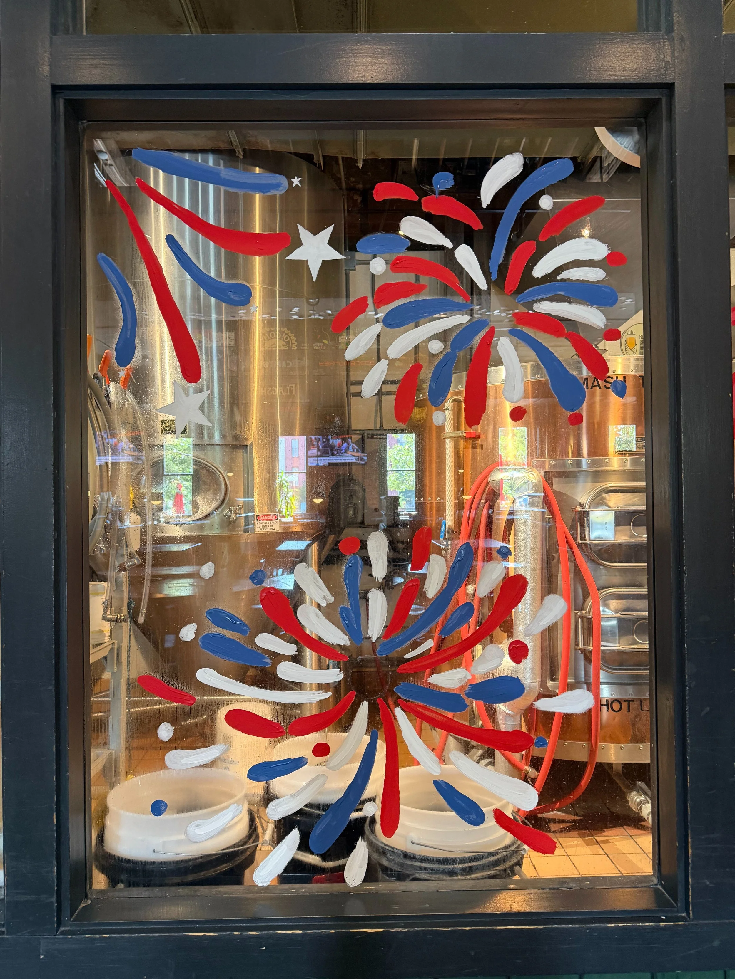 red, white, and blue fireworks on a window 