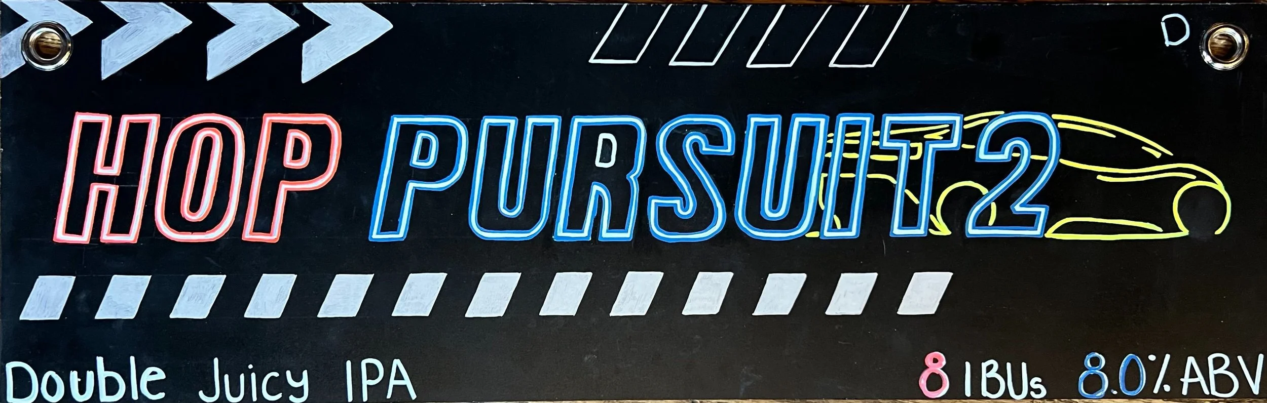 Chalk design that says HOP PURSUIT in red and blue. With an outline sketch of a racecar in yellow. Below says double juicy IPA