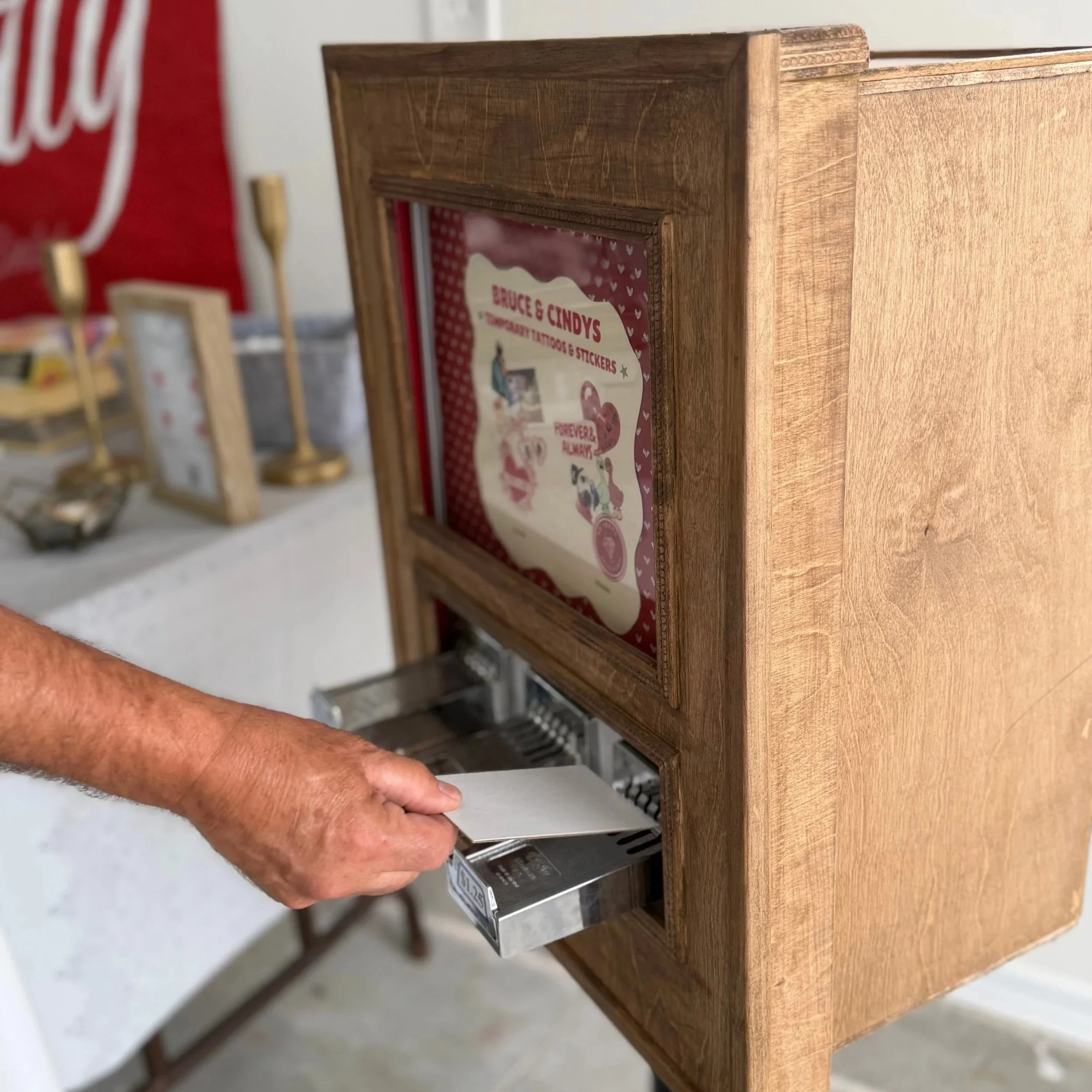 photo of an old sticker vending machine with a mans hand taking out the sticker of the machine