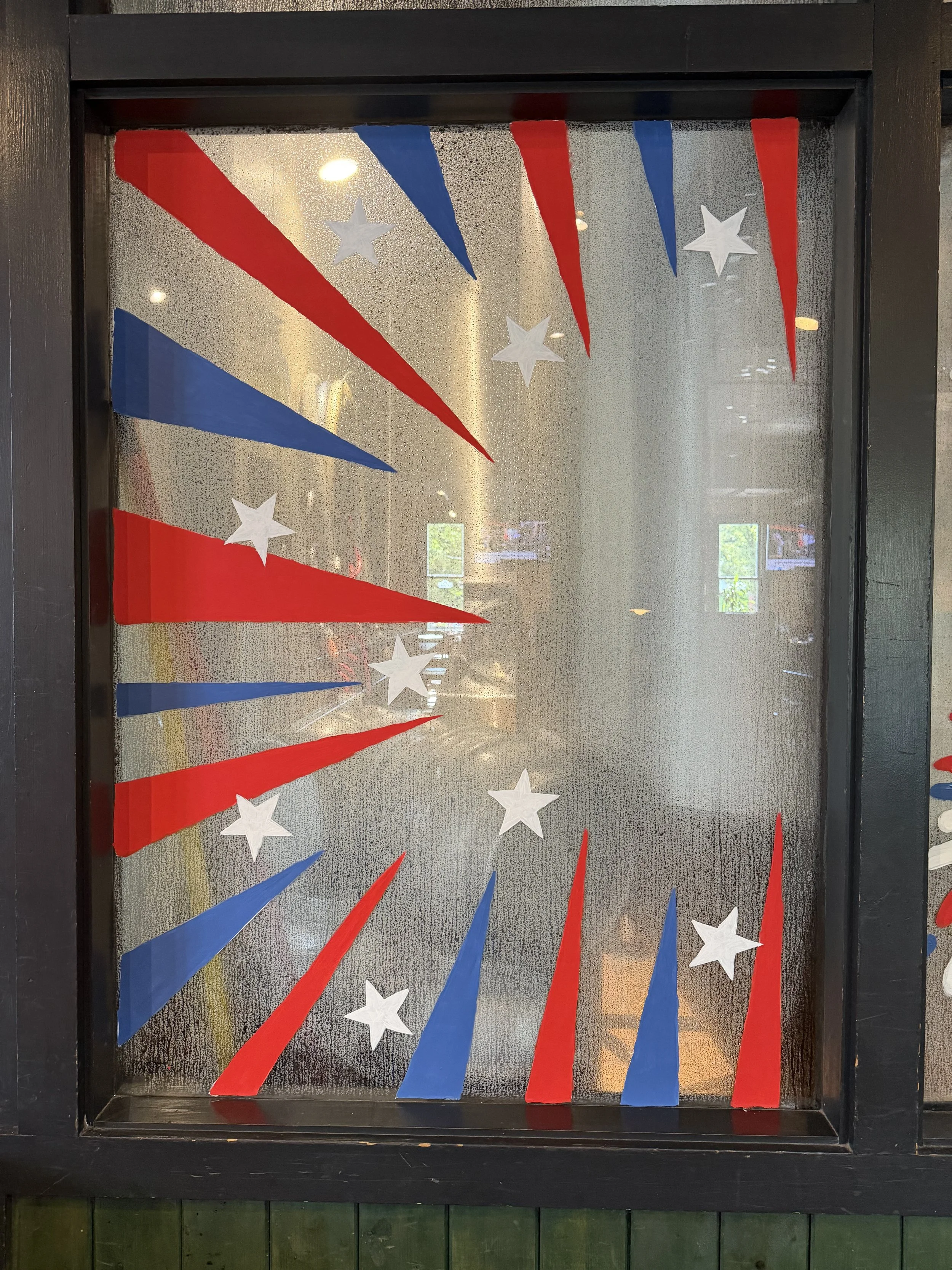 red and white stripe triangles pointed toward the right around the window with white stars