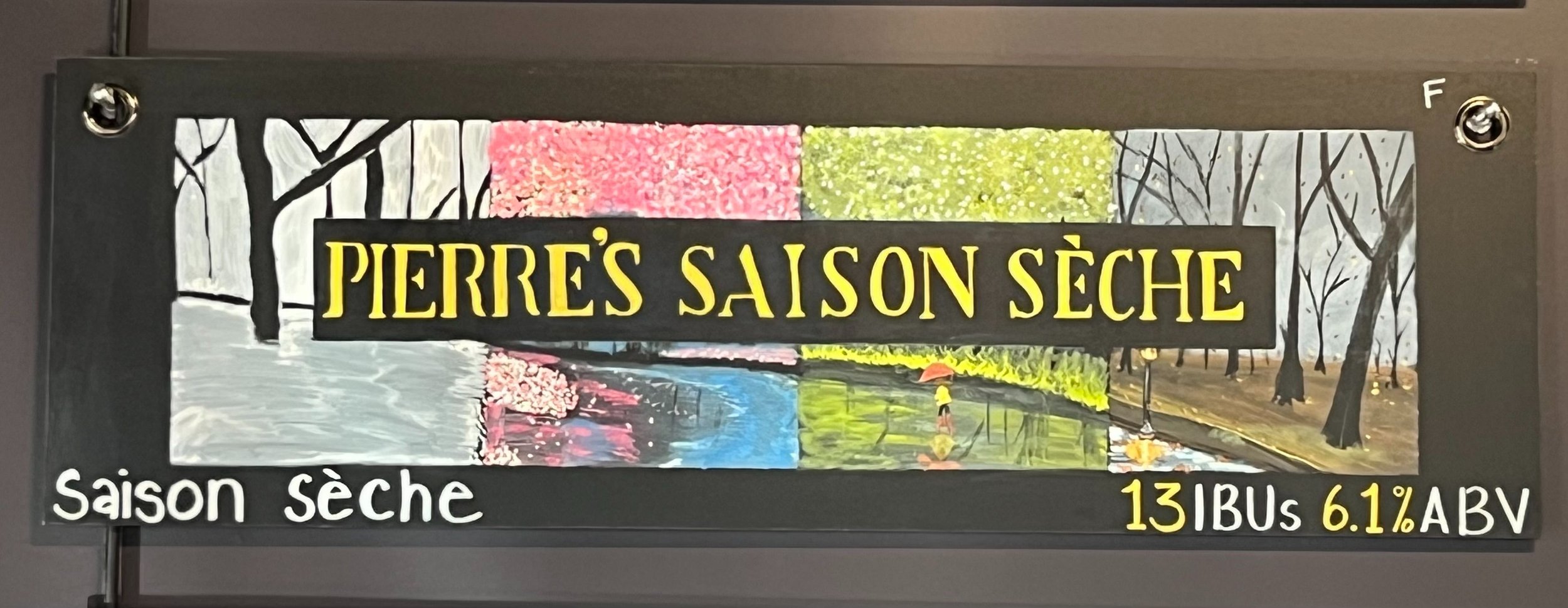 Chalk art of the four seasons with the words Pierre's Saison Seche in the middle.