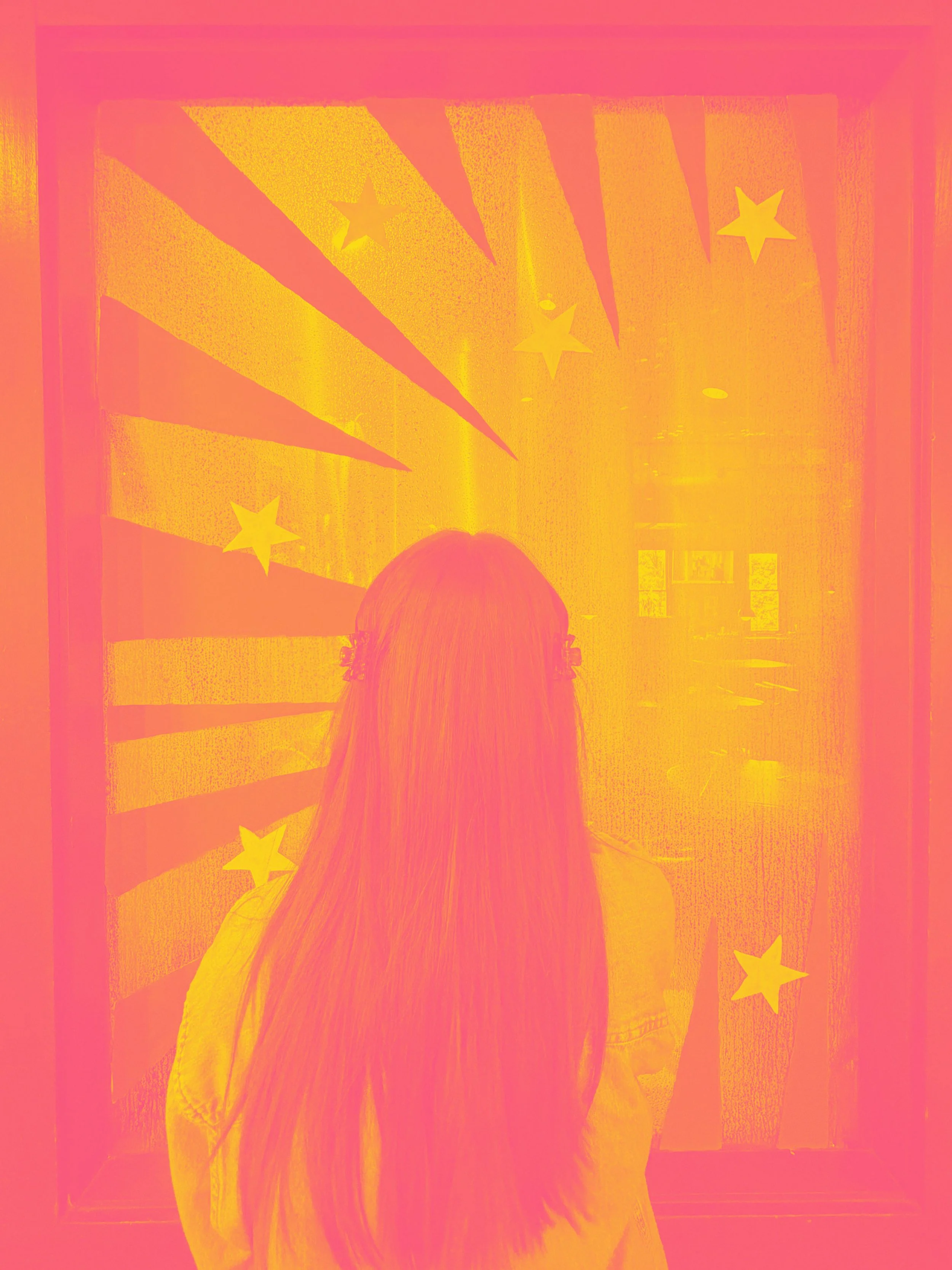 Photo of woman in front of window art. Photo is in a pink and yellow hue