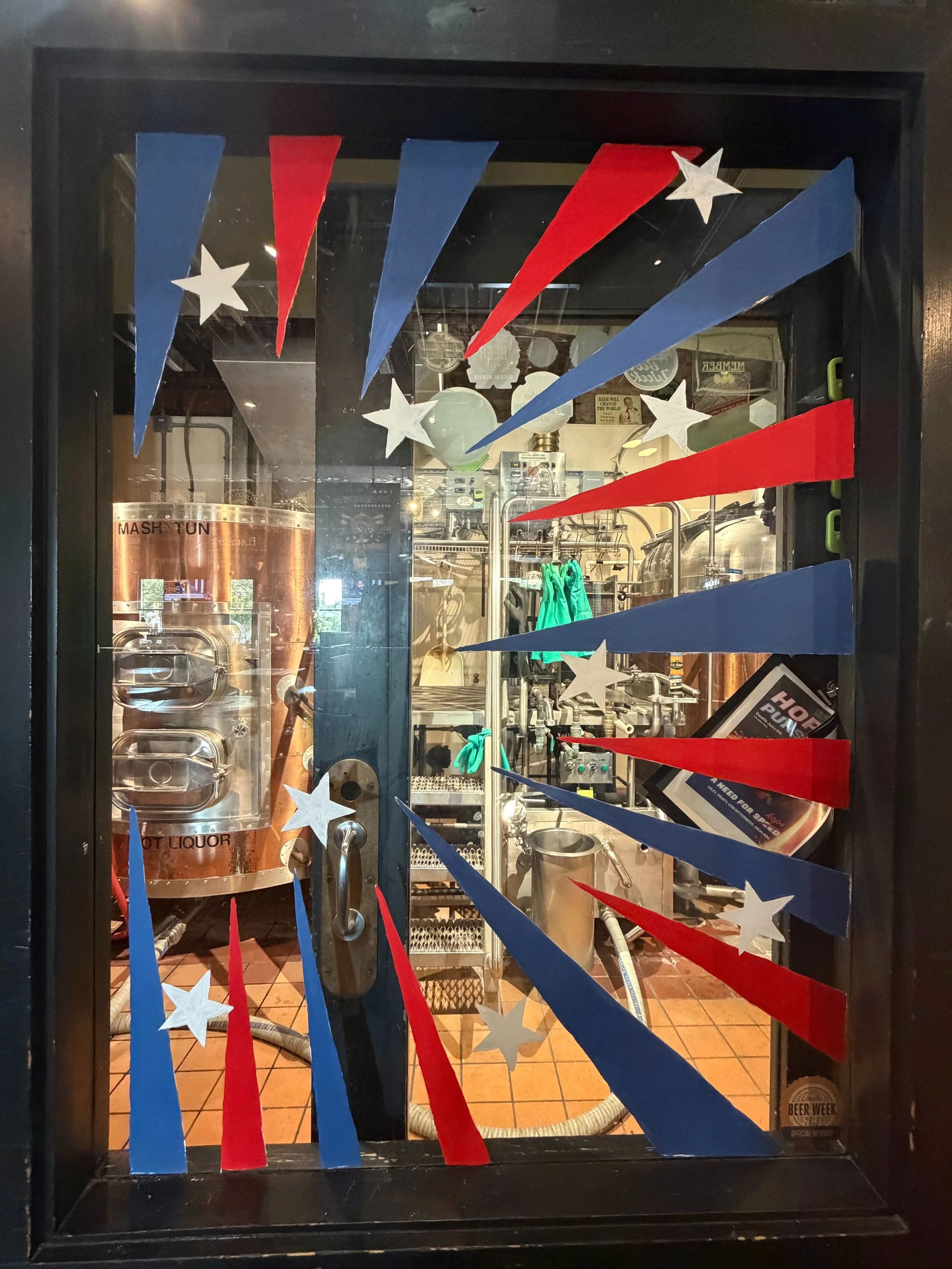 red and white stripe triangles pointed toward the left around the window with white stars