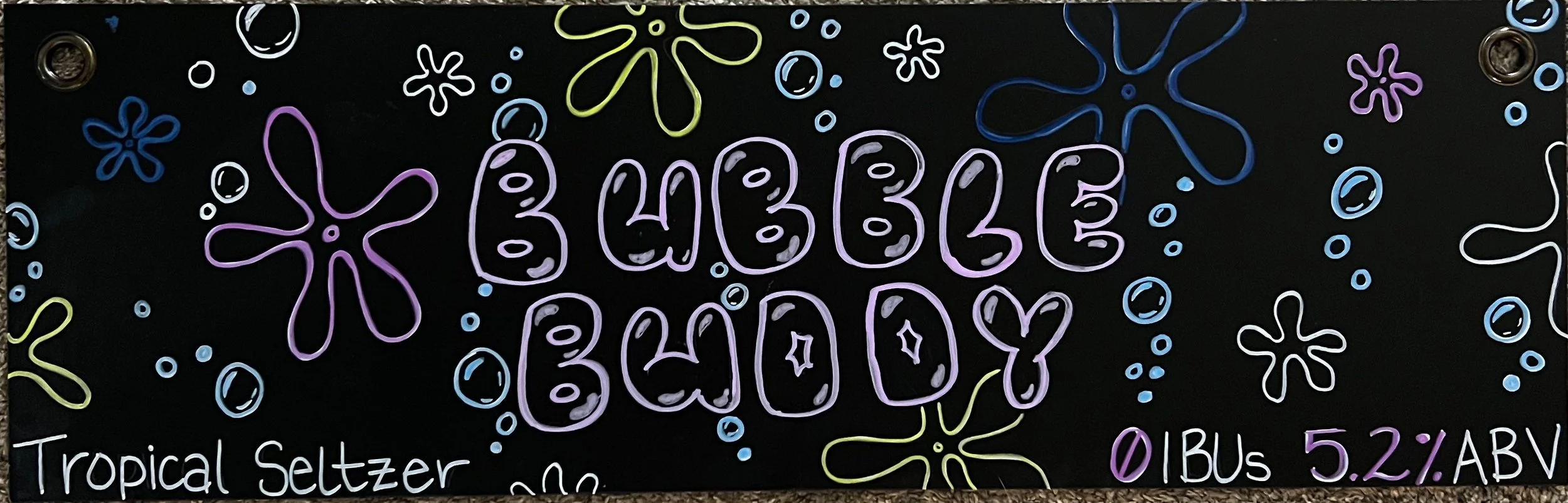 SpongeBob-inspired chalk design. Says BUBBLE BUDDY in bubble letters. With funky flowers and bubbles all around in purple, blue, and yellow colors. Says Tropical Seltzer at the bottom.