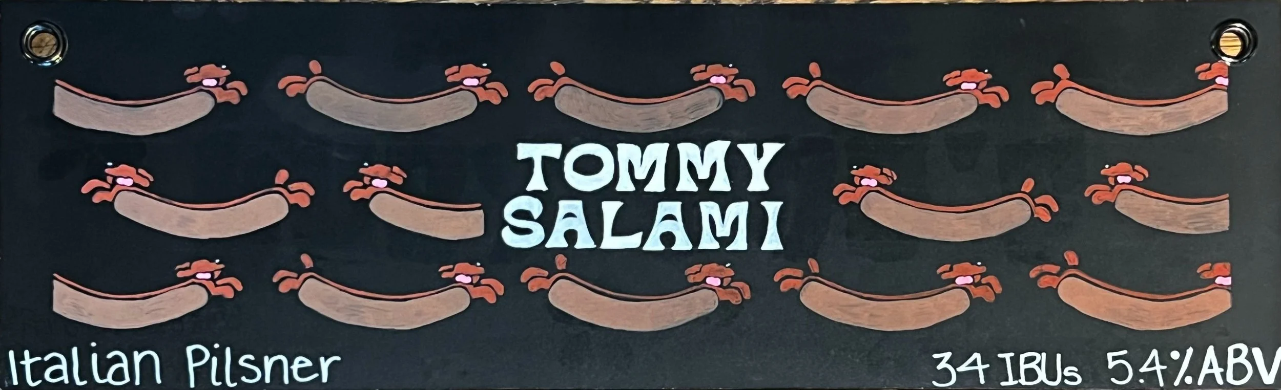 Chalk design of multiple wiener dogs as hot dogs. In the middle says Tommy Salami. At the bottom reads Italian pilsner.