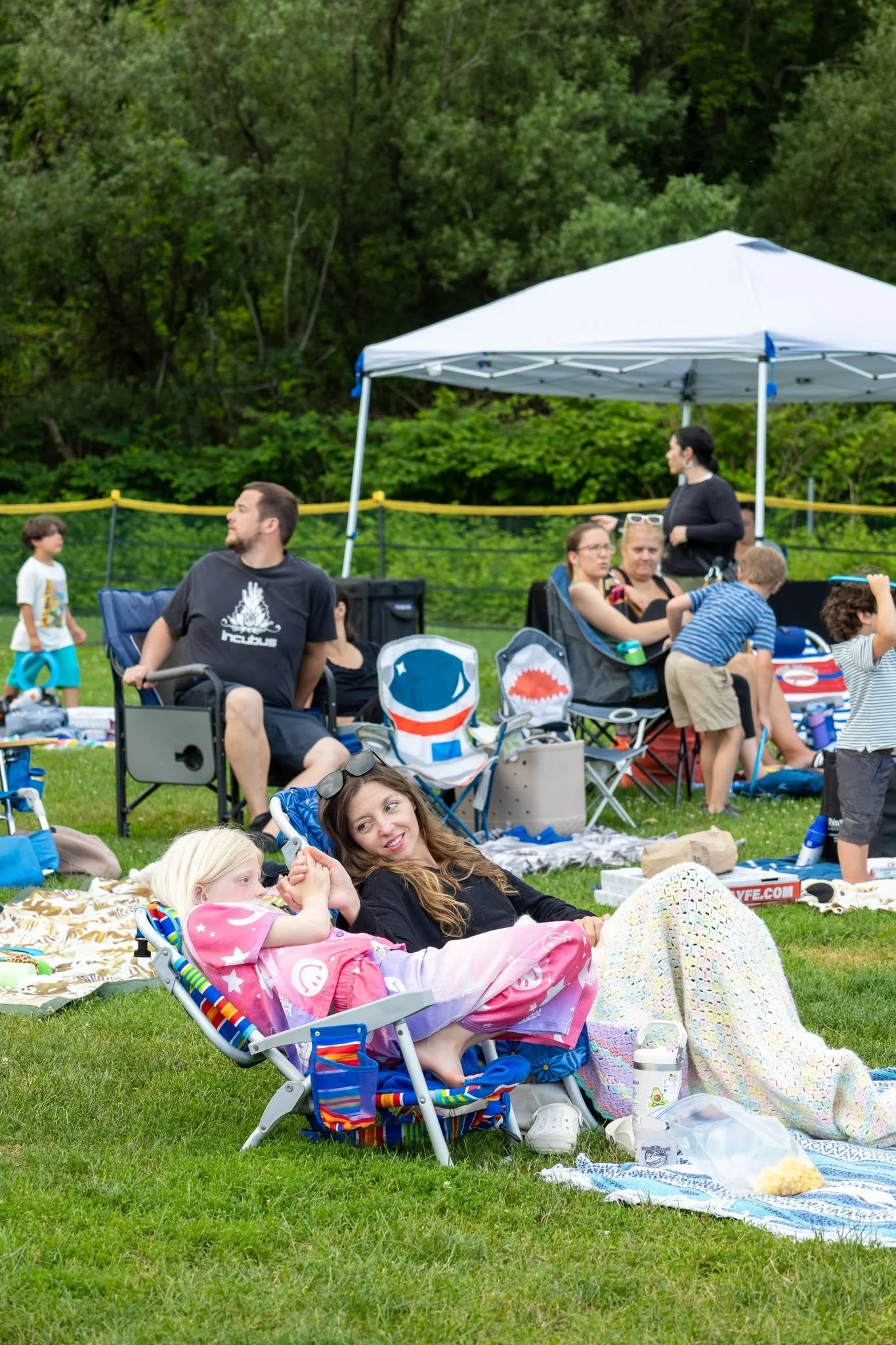 Downtown Milford summer events: Outdoor movie night featuring local residents on blankets. Every wednesday in july summer outdoor movies in downtown milford organized by the Downtown Milford Business Association.