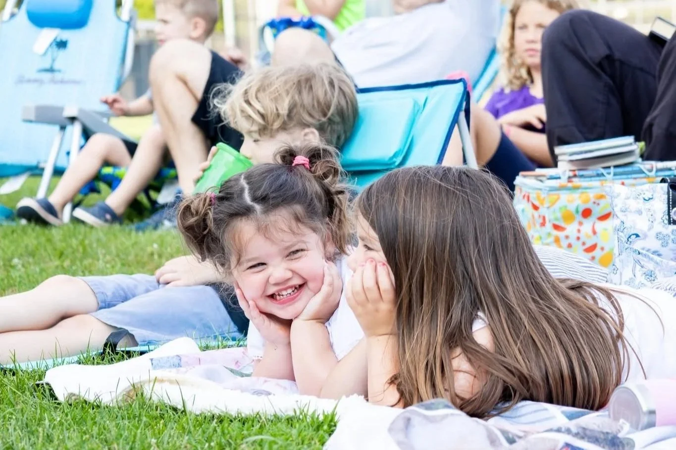 Downtown Milford summer events: Outdoor movie night featuring local residents on blankets. Every wednesday in july summer outdoor movies in downtown milford organized by the Downtown Milford Business Association.