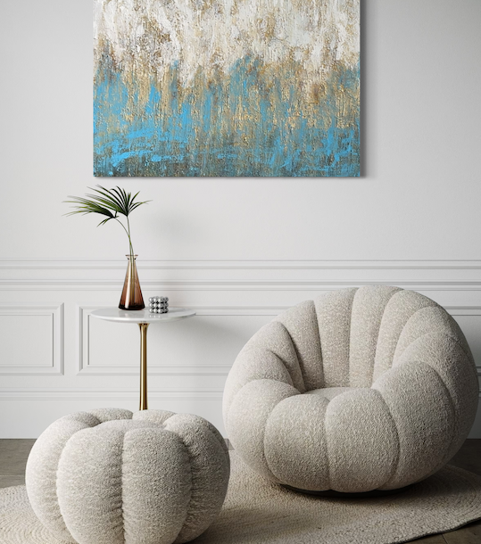 Coastal contemporary living room staging with a round, plush armchair and matching ottoman, abstract painting on the wall in Southern California