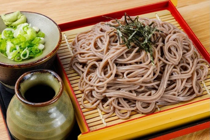 Cold buckwheat soba noodles with shredded nori, green onions, wasabi, and dipping sauce