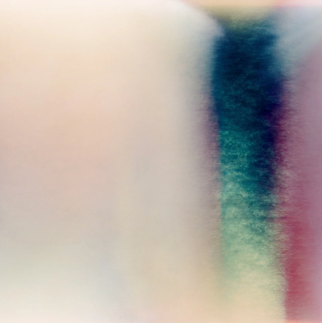 Abstract blurry image with pastel hues of pink, blue, green, and white, with no discernible objects or details.