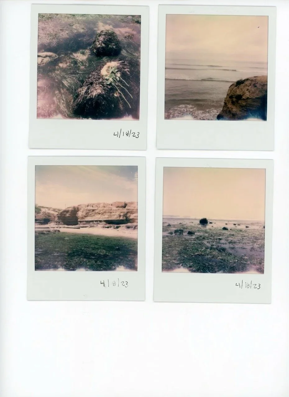 Four Polaroid photos of natural landscapes, each dated 4/10/23. The top left shows a close-up of a volcanic rock formation with steam; the top right features a calm ocean view with rocky cliffs; the bottom left shows layered rock formations by a body of water; and the bottom right depicts a rocky shoreline with several rocks scattered on the beach.