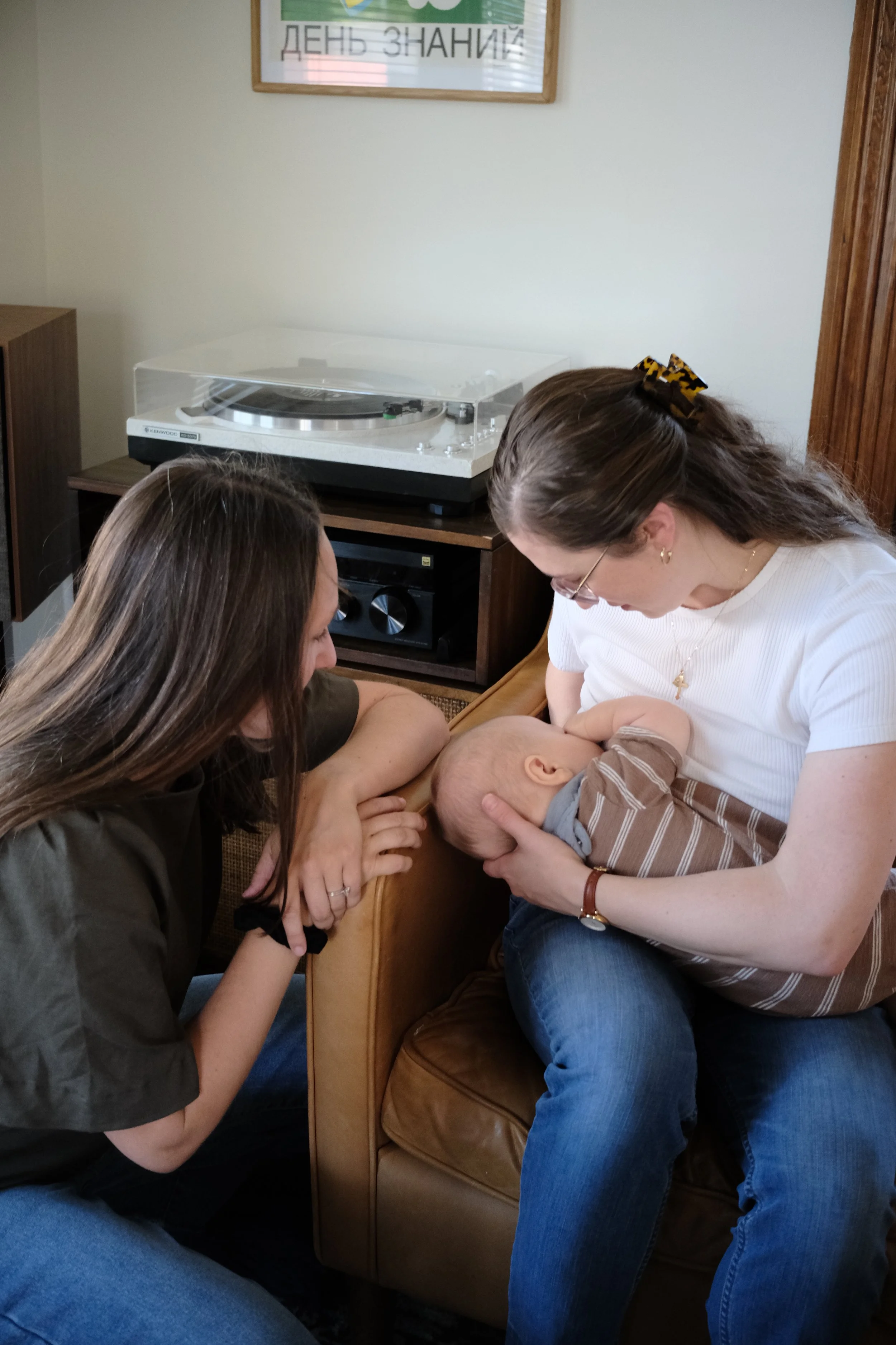 Lactation consultant IBCLC helping mom breastfeeding during  lactation weighted feed at in-home visits Omaha, NE