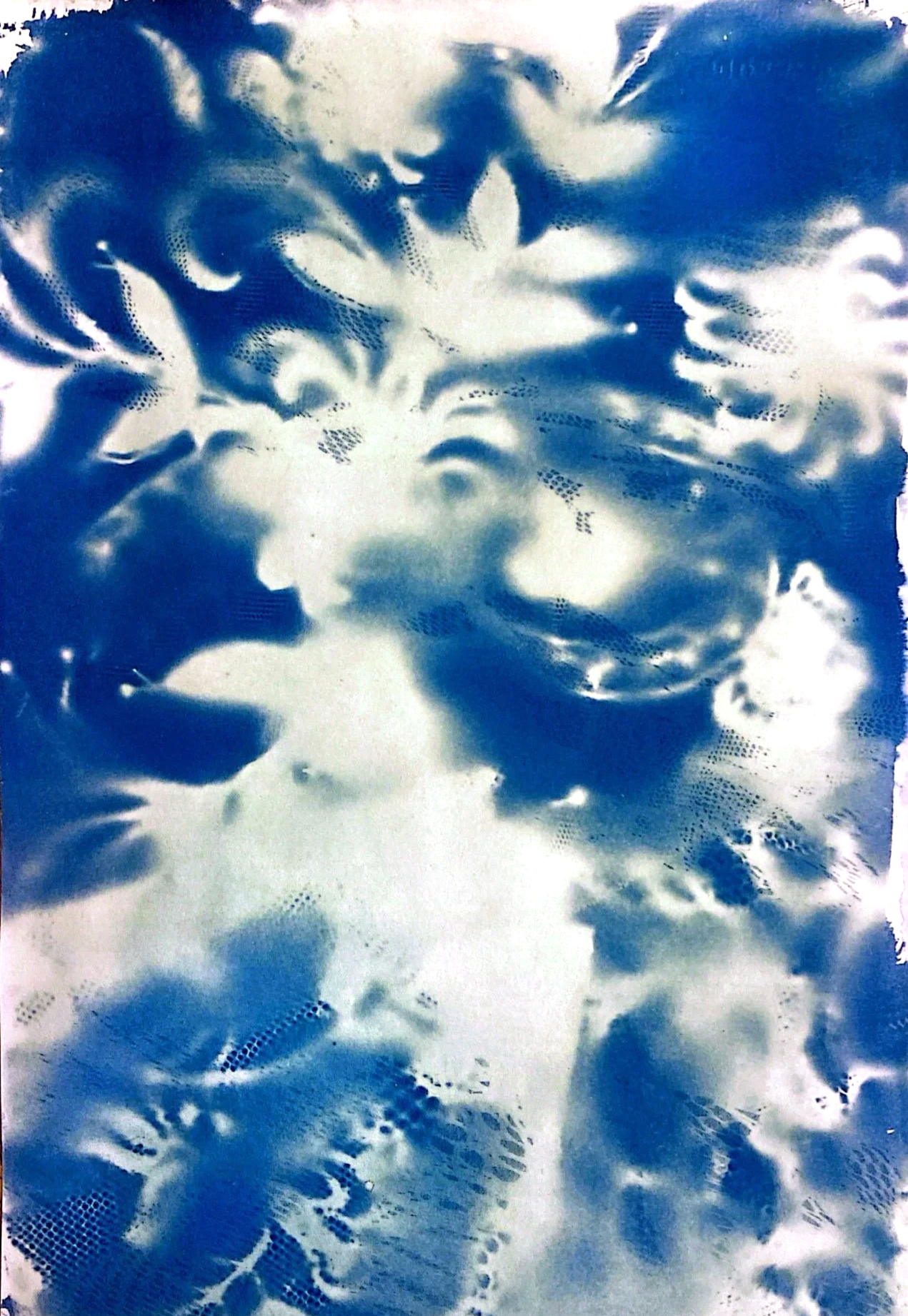 Abstract image with blue and white cloud-like patterns and dotted textures.