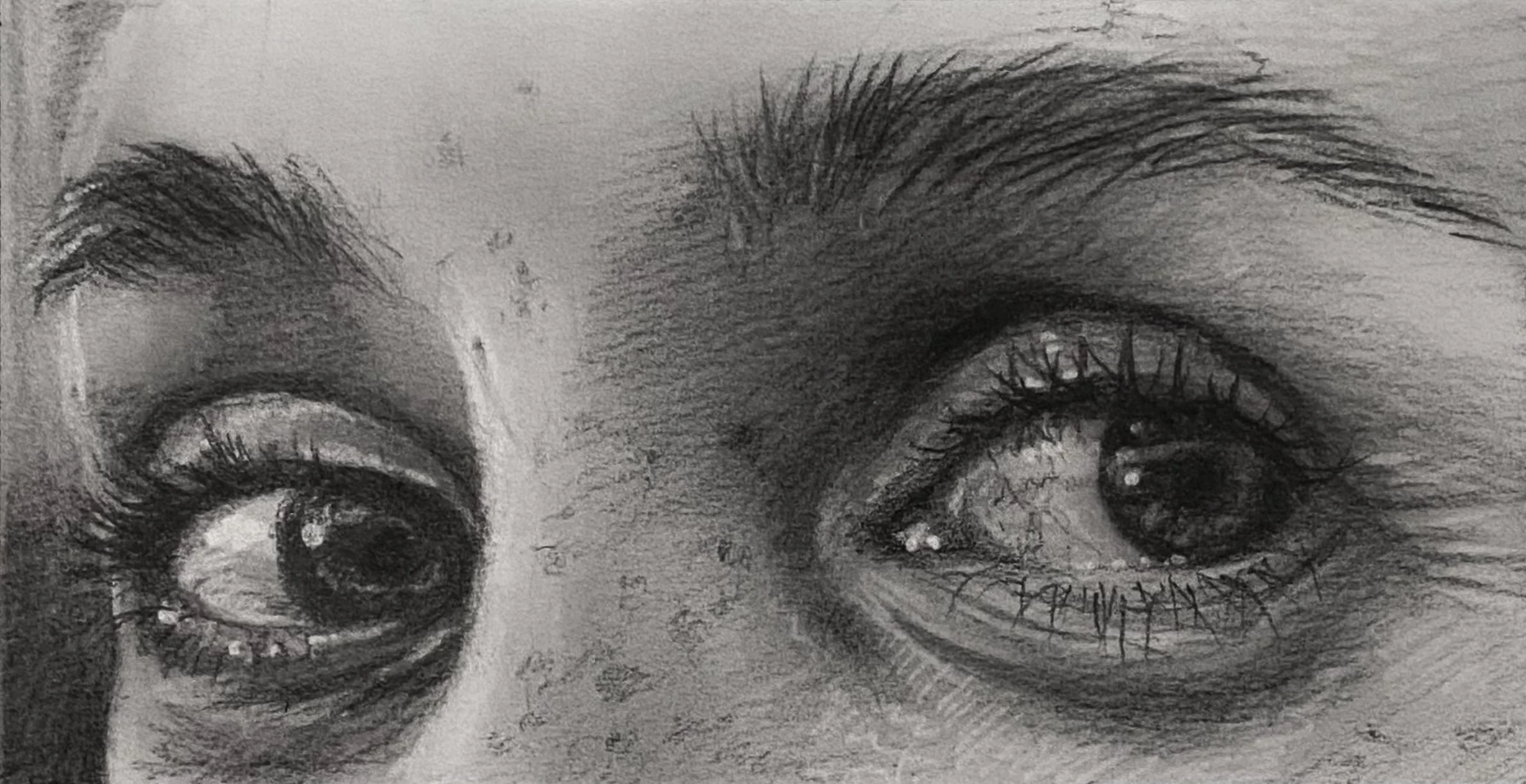 Close-up of a pencil sketch of two human eyes with detailed eyelashes, eyebrows, and reflections in the pupils, drawn in black and white.