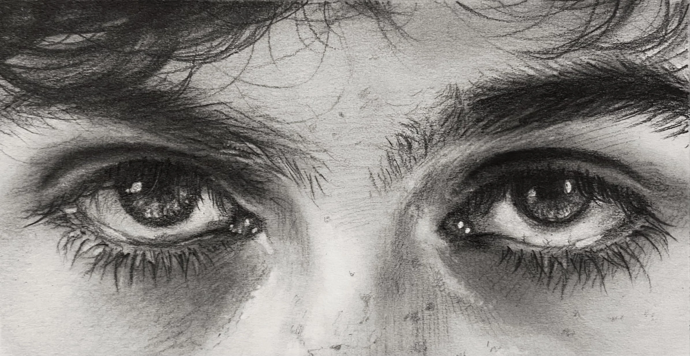 Close-up pencil sketch of human eyes with detailed eyelashes and eyebrows.