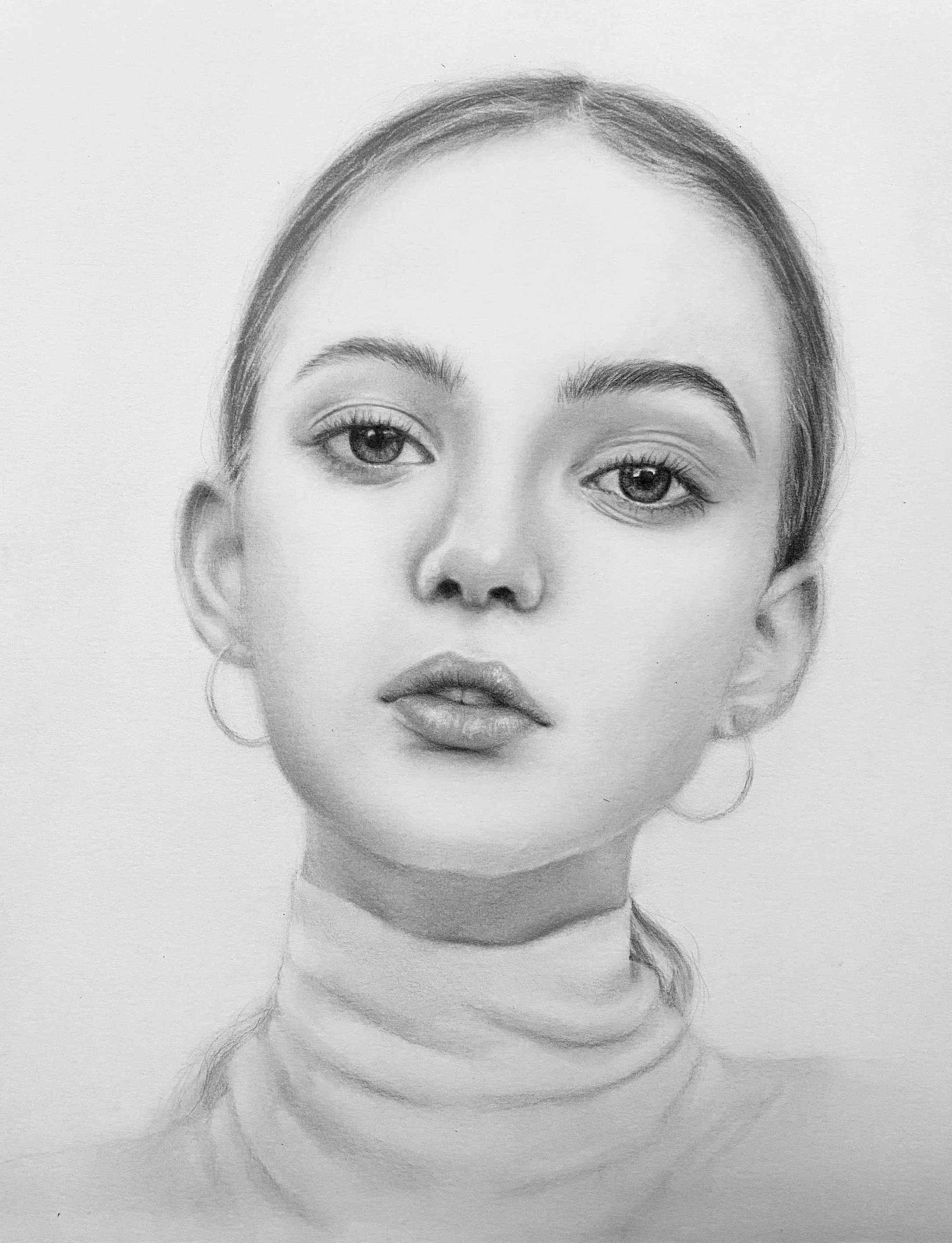 A realistic pencil sketch of a woman's face, showing her eyes, eyebrows, nose, lips, and earrings, with detailed shading and hair outline.