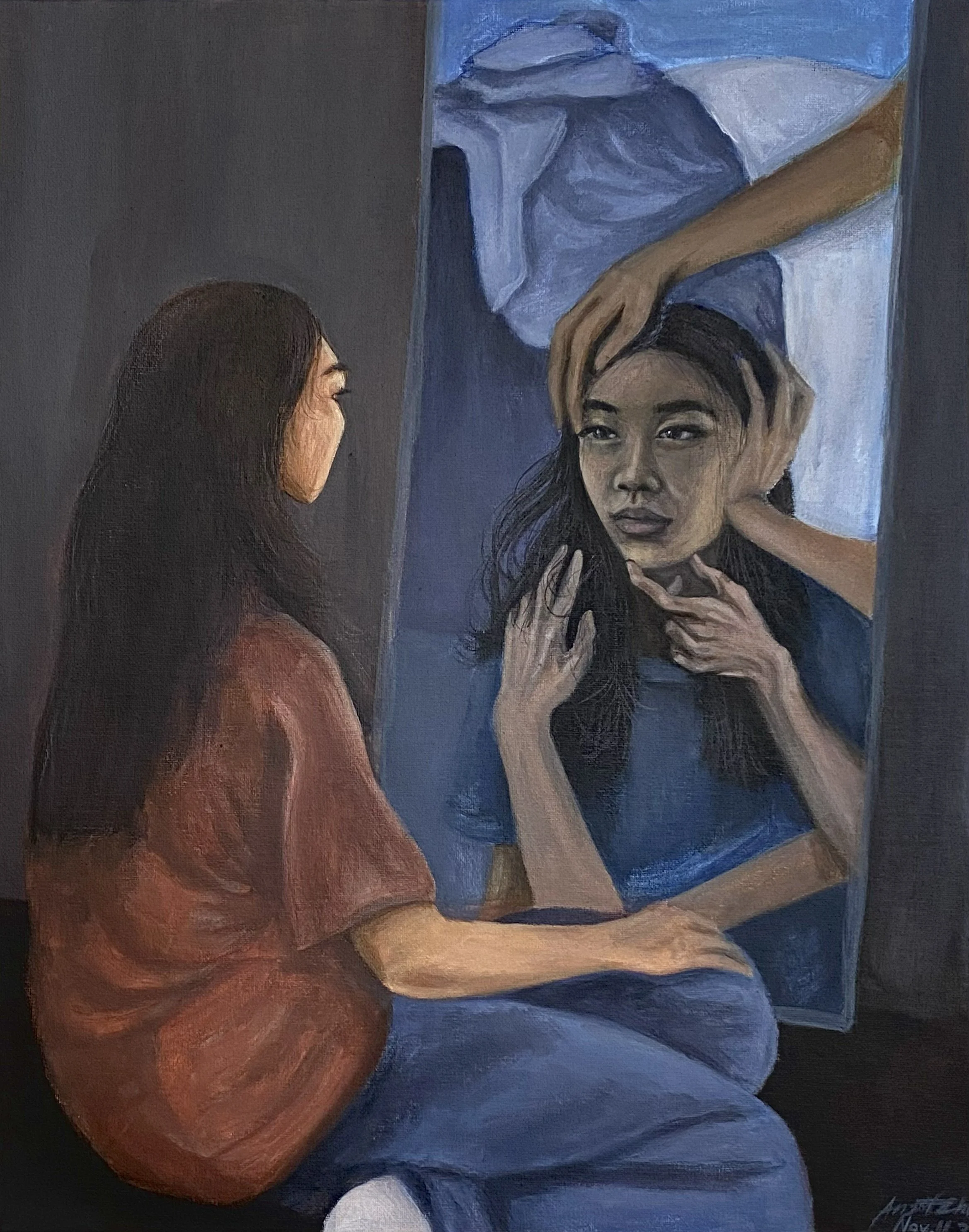 A woman with long dark hair, wearing a red-brown shirt, sitting in front of a mirror with her reflection distorted.