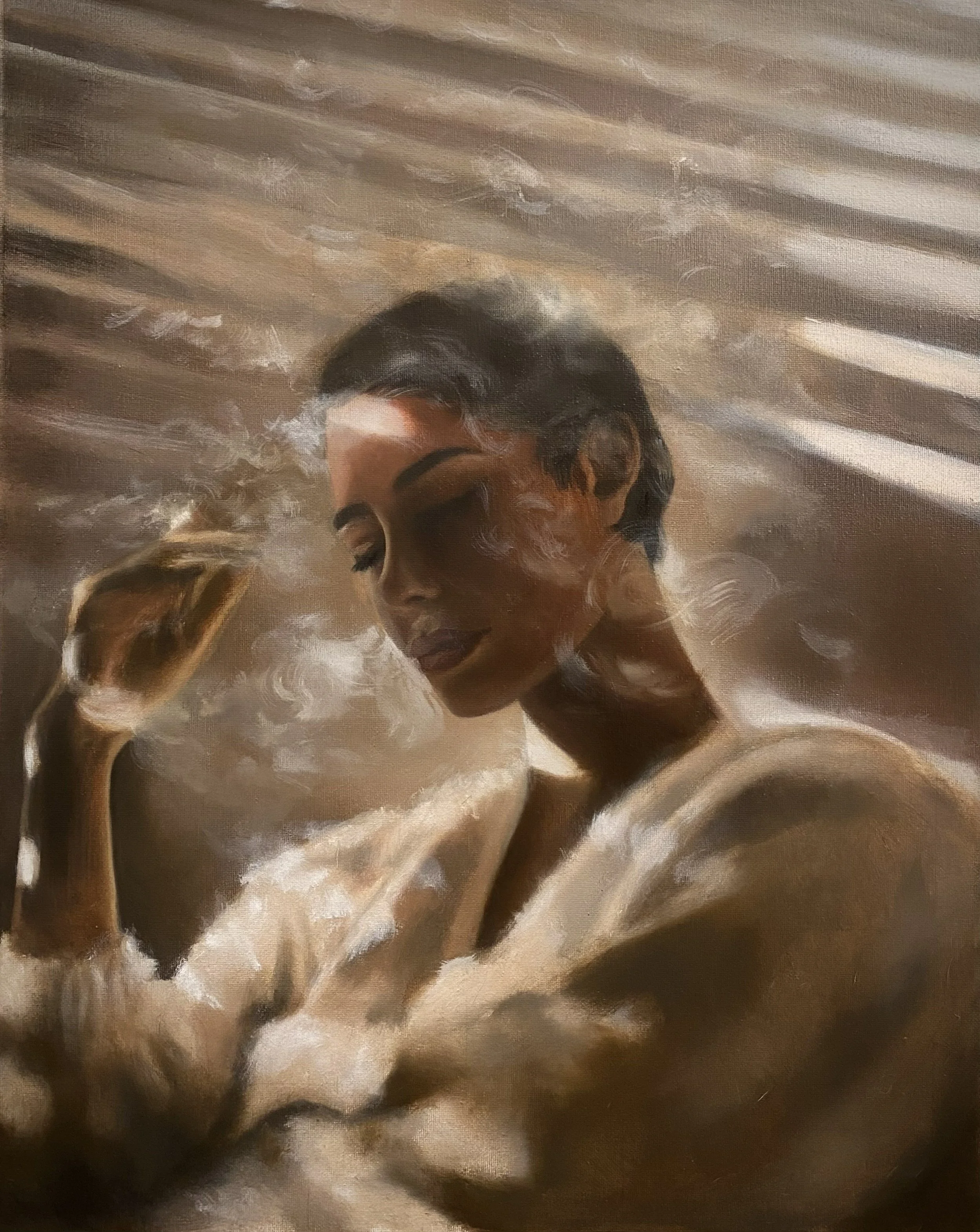 A woman with dark hair and closed eyes, looking down and surrounded by smoke.