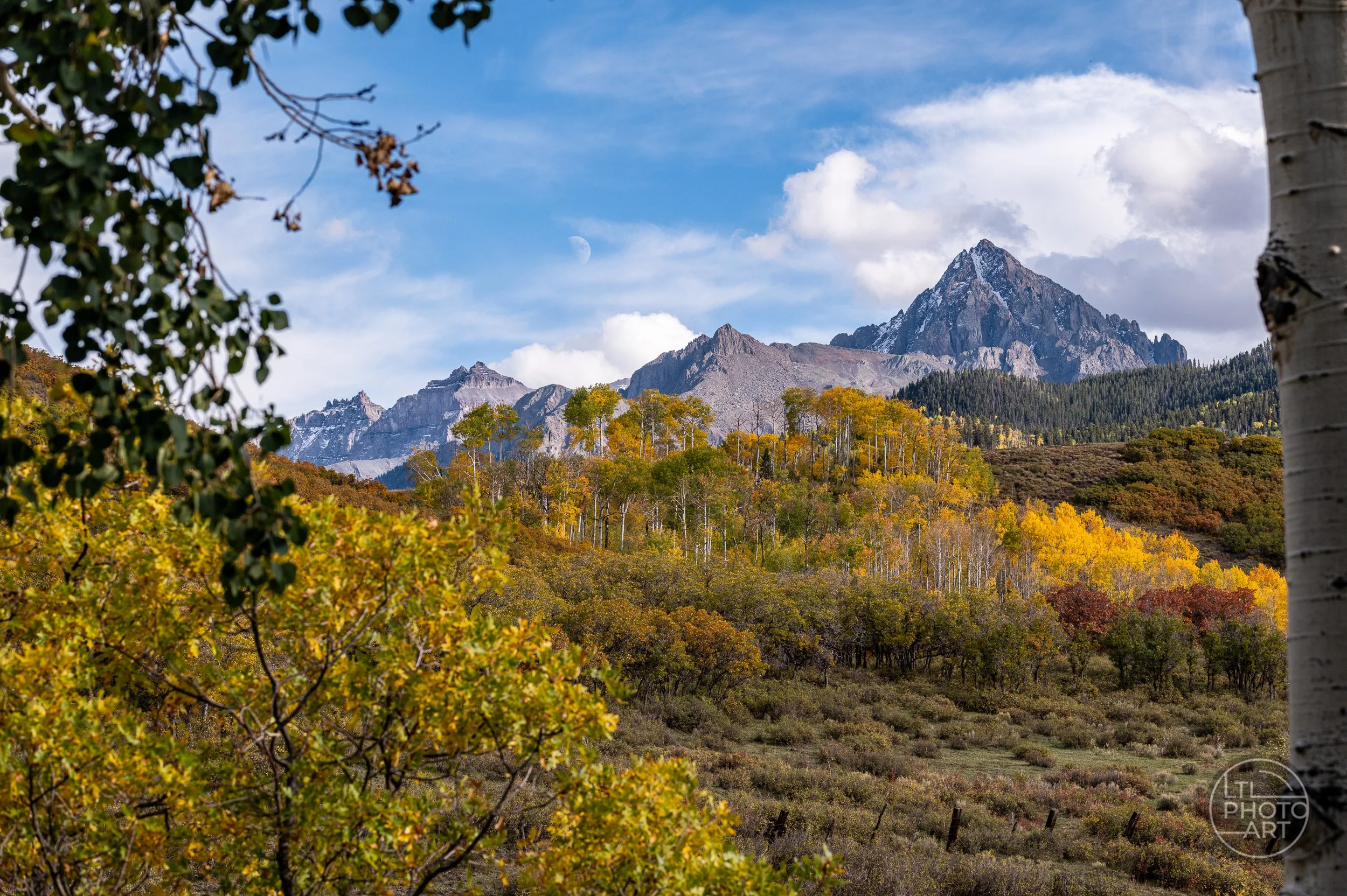 Autumn aspens and rugged mountain peaks near Owl Creek Pass in the Uncompahgre National Forest, Colorado.