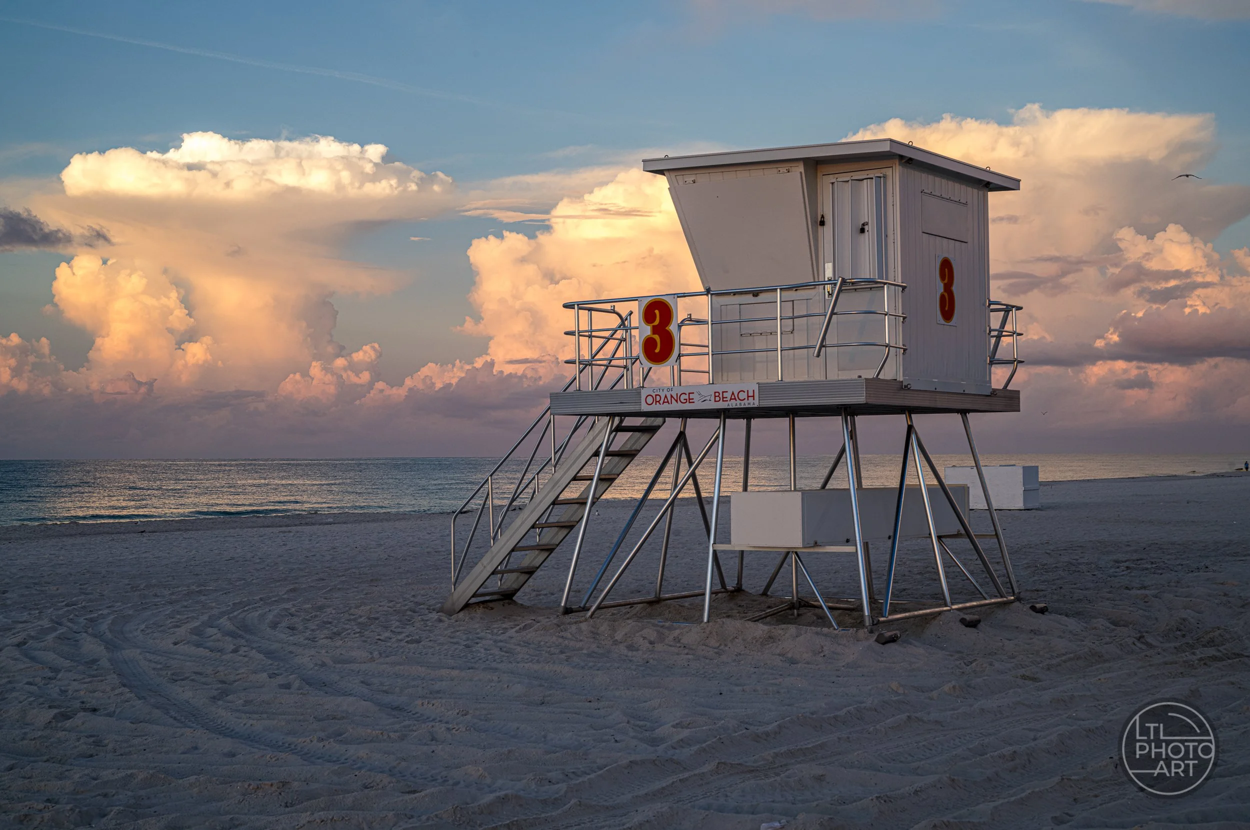 Tower 3 at Cotton Bayou Public Beach Access in Orange Beach, Alabama, at sunrise with dramatic clouds over the Gulf of Mexico.