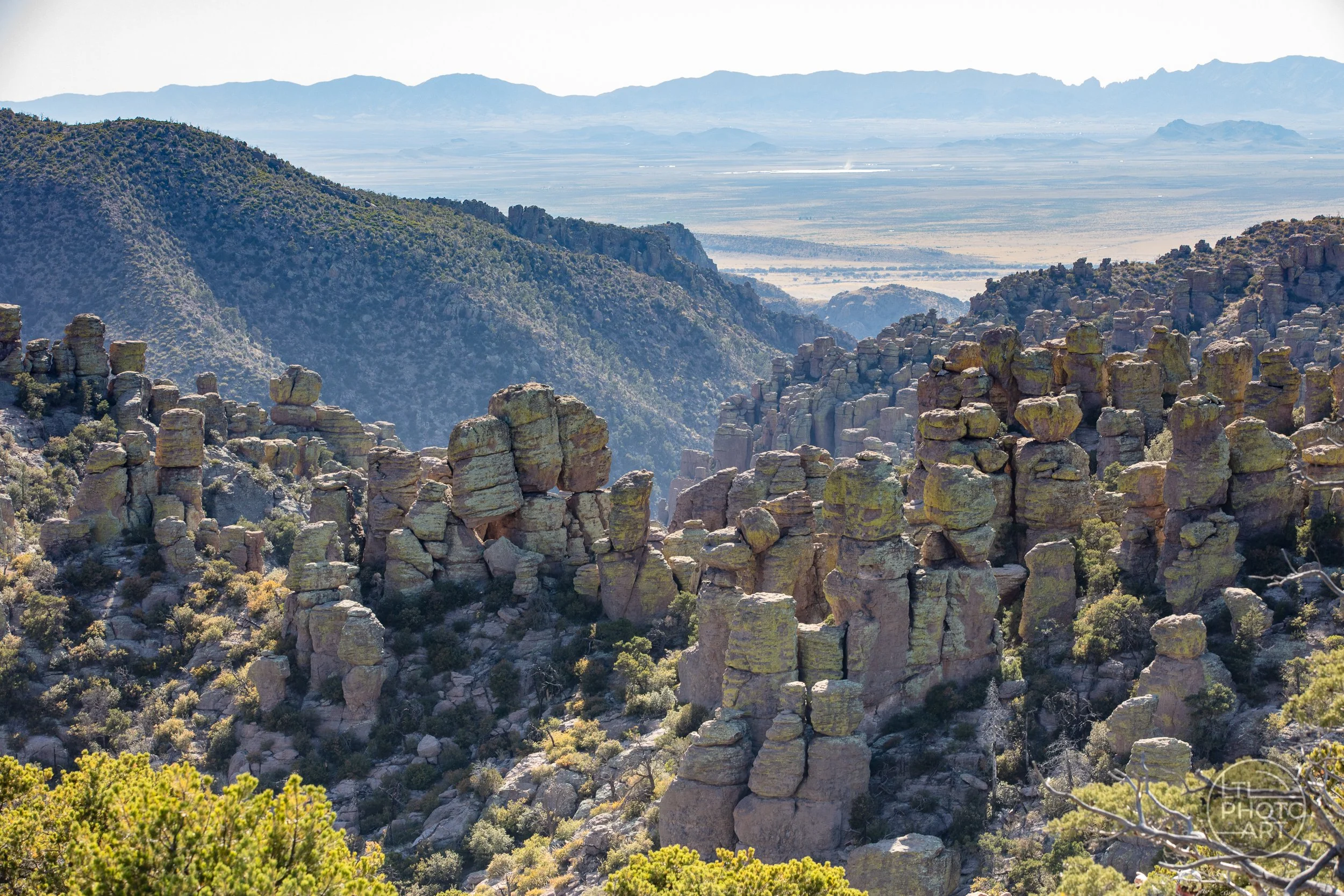 Rhyolite hoodoos, rock pinnacles, and distant desert mountains at Chiricahua National Monument near Willcox, Arizona.