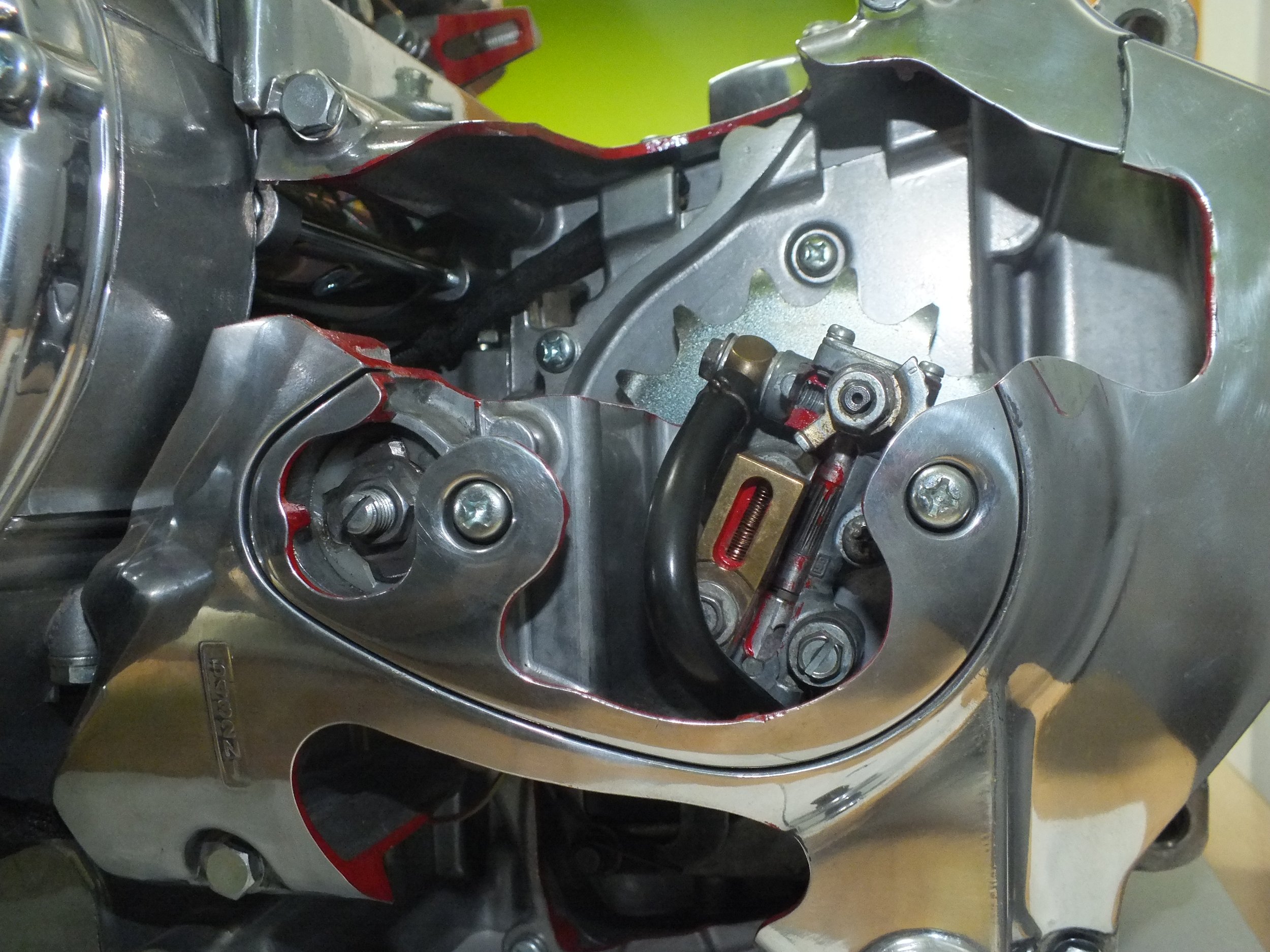 Close-up of a partially assembled metal engine or machine component with bolts and machinery parts.