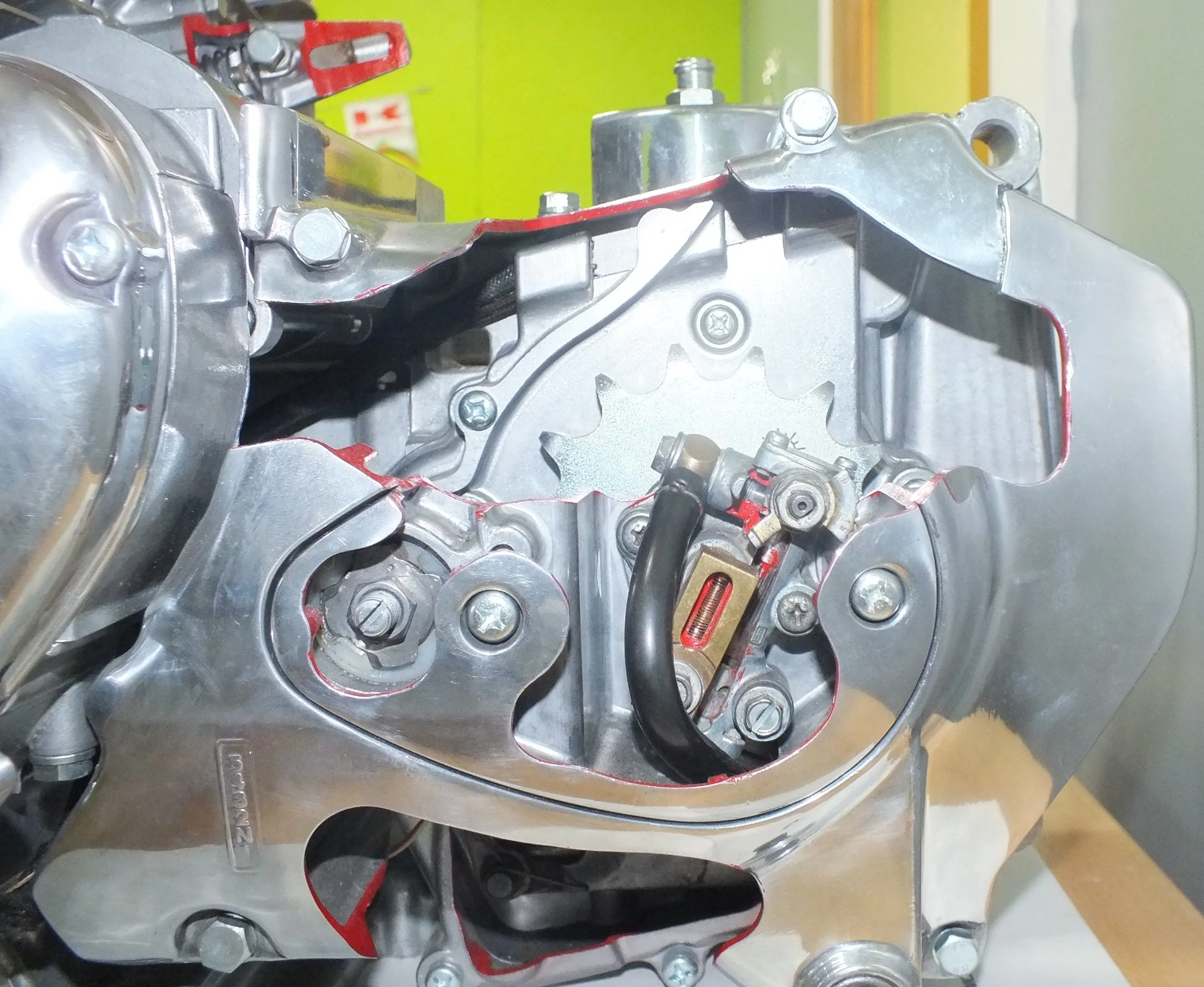Close-up of a metallic engine or machinery part with bolts and wires, possibly an automotive engine component.