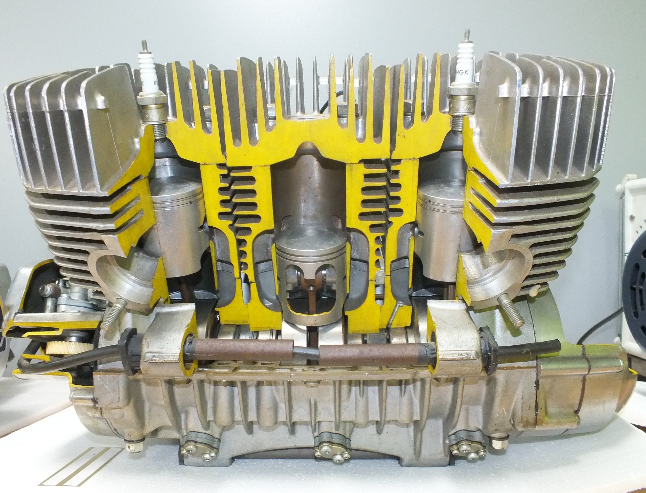 An internal view of an aircraft engine showing cylinders, cooling fins, and spark plugs.