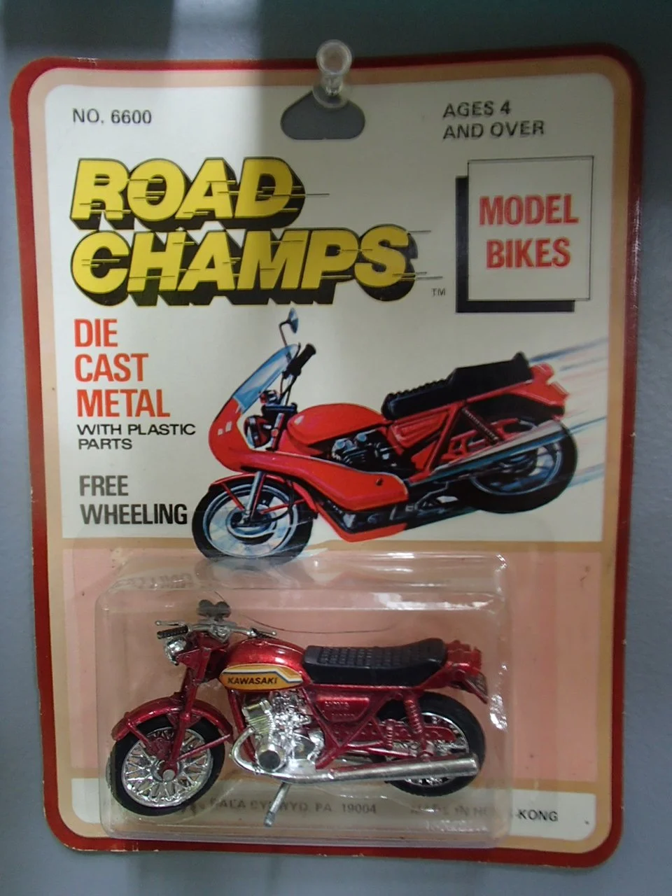 Red model motorcycle toy packaged on a blister card with a label that reads 'Road Champs' and 'Model Bikes'.