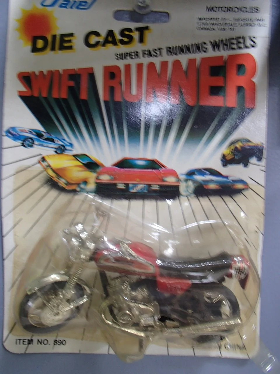 A vintage toy die-cast model car packaging titled "Swift Runner" with a motorcycle, and illustrations of sports cars racing on a track.